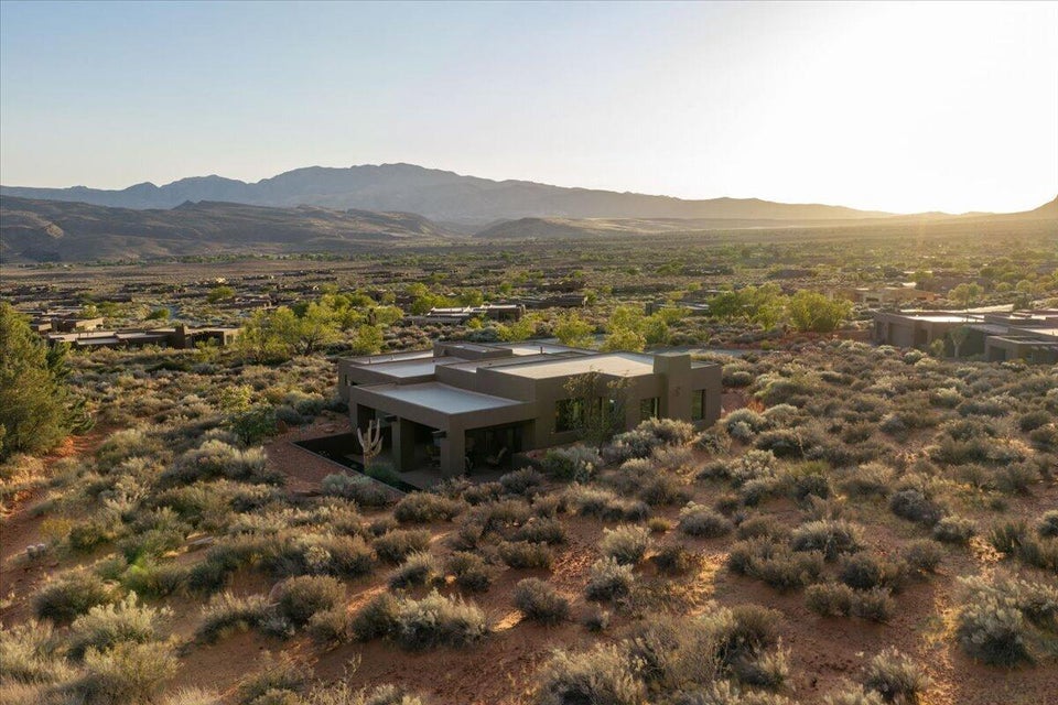 Desert landscape featuring a modern architectural residence with a flat roofline and integrated outdoor living space
