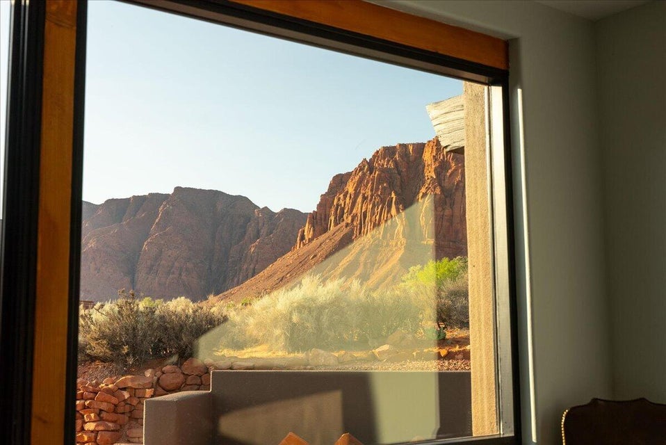 Expansive window framing desert landscape with red rock formations