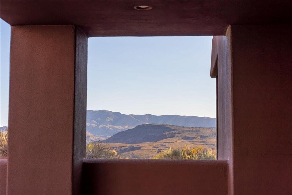 Framed mountain landscape with distant peaks and natural desert foliage