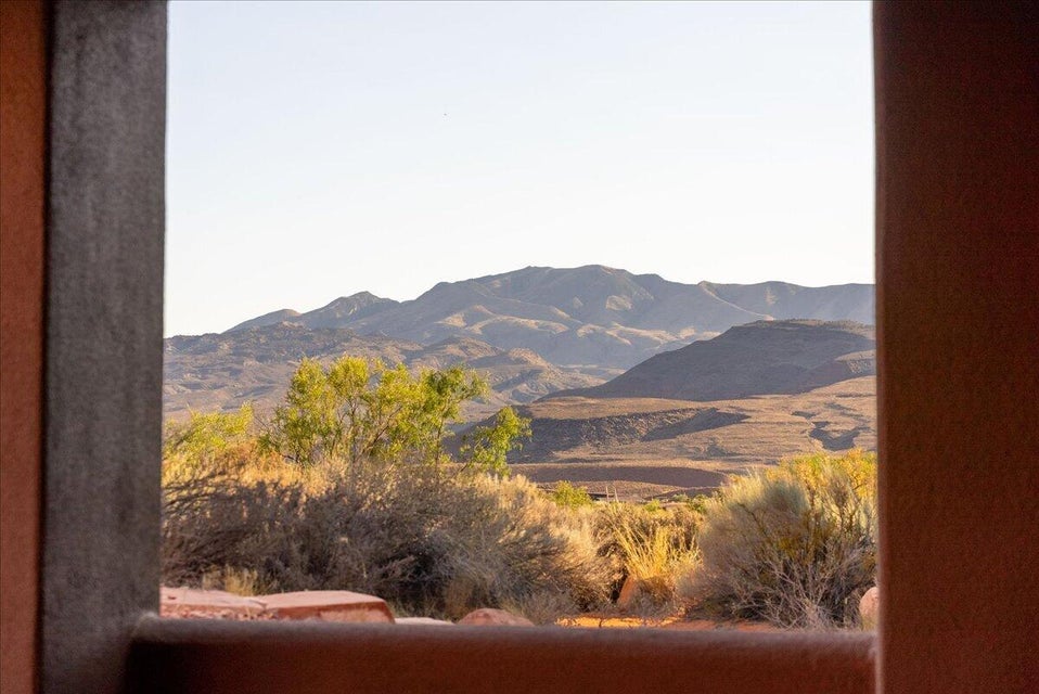 Framed desert landscape with distant mountains and natural vegetation