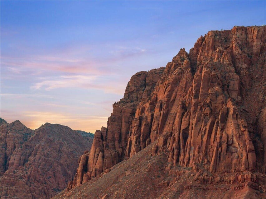 Dramatic red rock formations with a rugged, textured surface