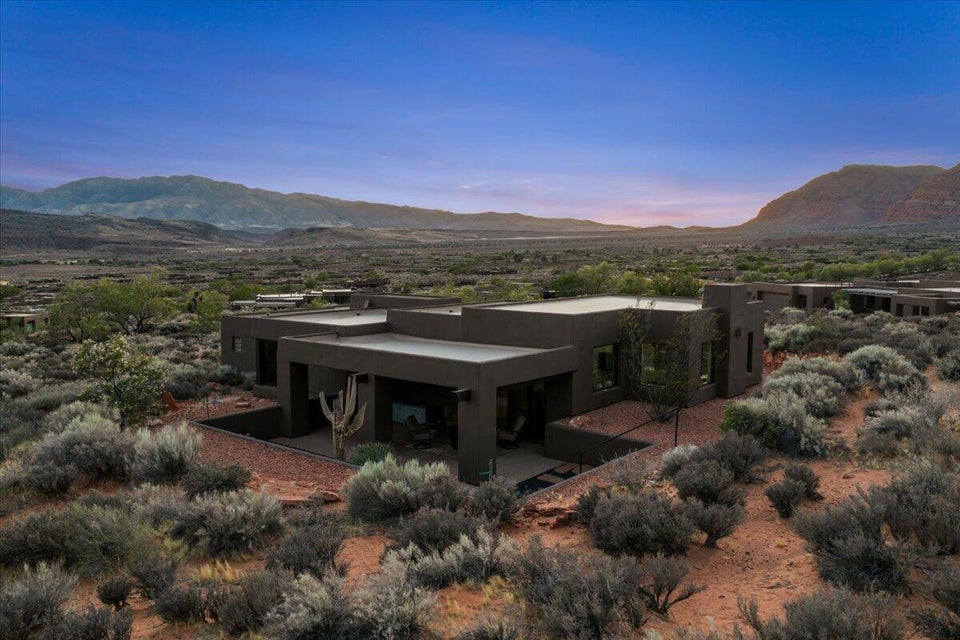 Modern desert dwelling featuring flat roofs and a dark exterior finish