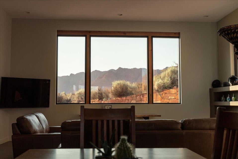 Expansive triple-pane window showcasing mountain terrain