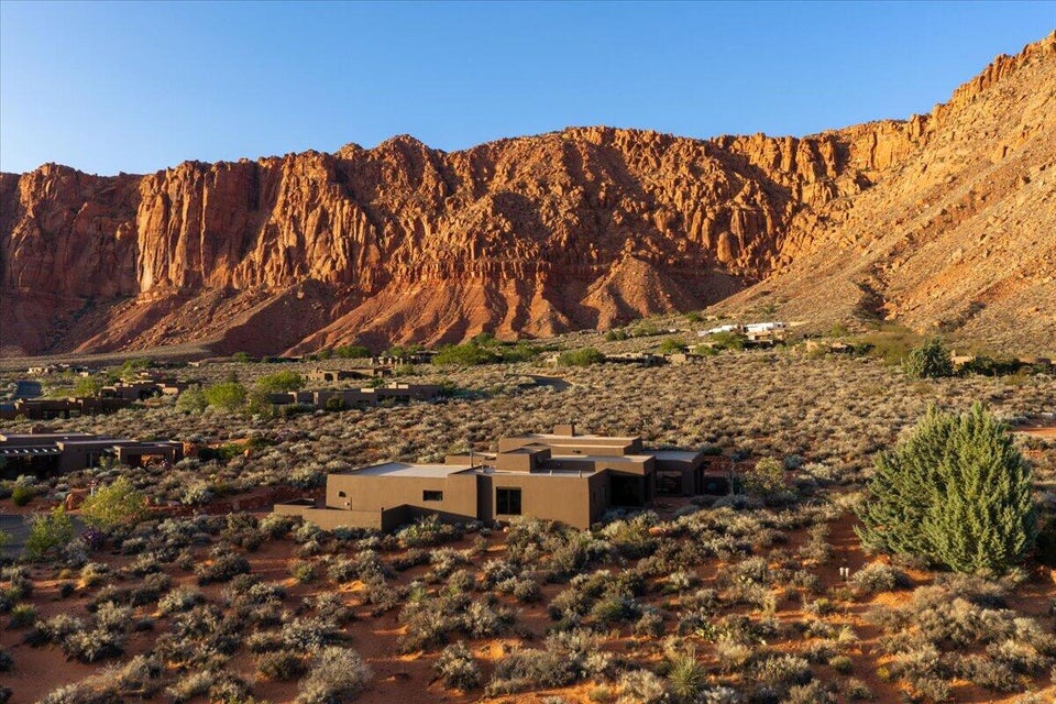 Contemporary desert architecture featuring a flat roofline and earth-toned stucco siding