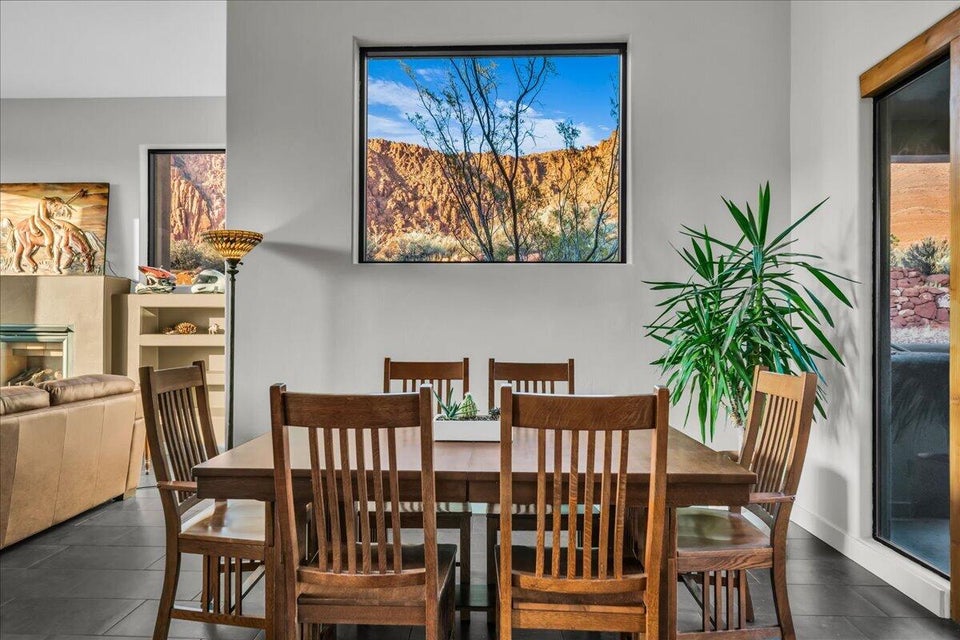 Dining space featuring sleek tile flooring, a large square window showcasing desert scenery, and neutral wall tones