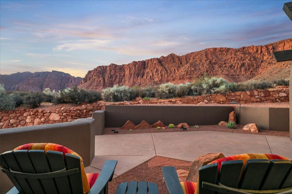 Expansive outdoor patio with concrete paving and desert landscaping