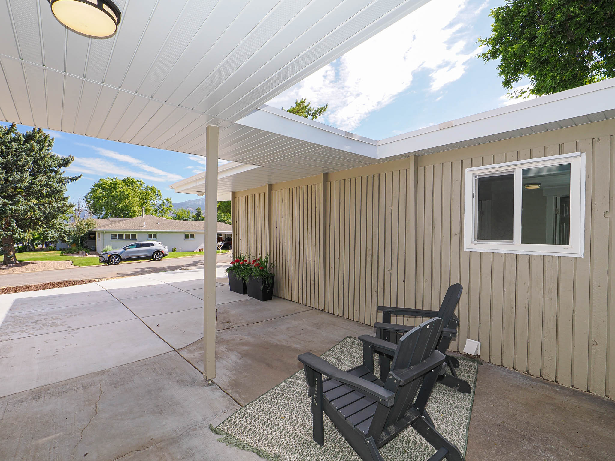 Covered patio area featuring a white slatted ceiling, recessed lighting, and direct access to an exterior window