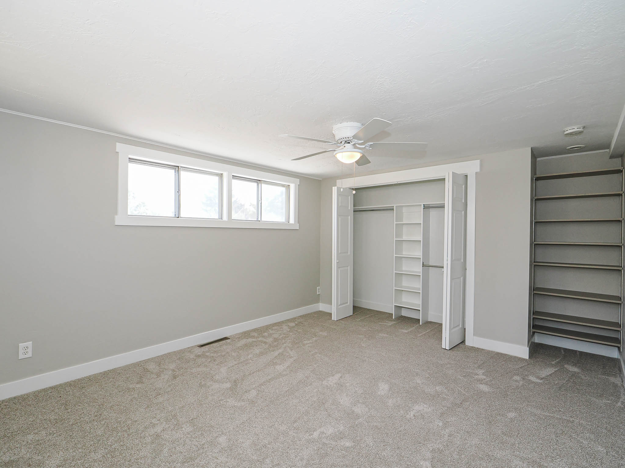 Neutral-toned carpeting and walls complement the white trim and ceiling