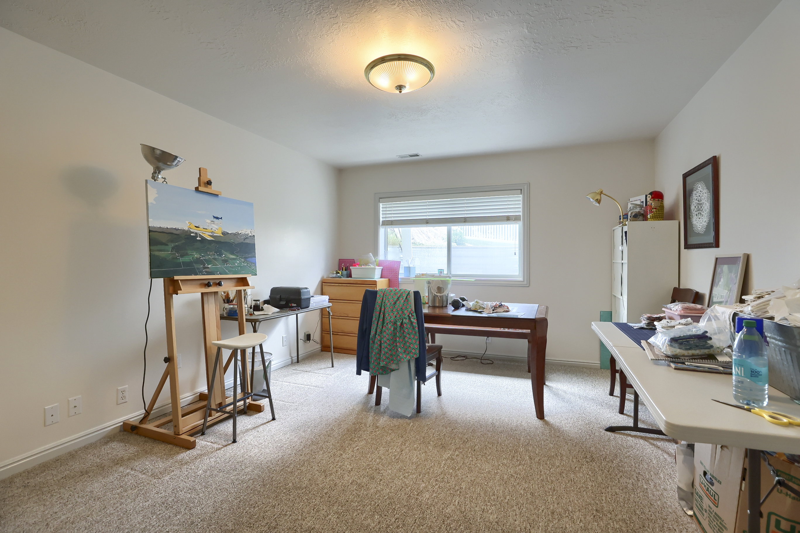 Spacious room featuring neutral carpet flooring and white painted walls