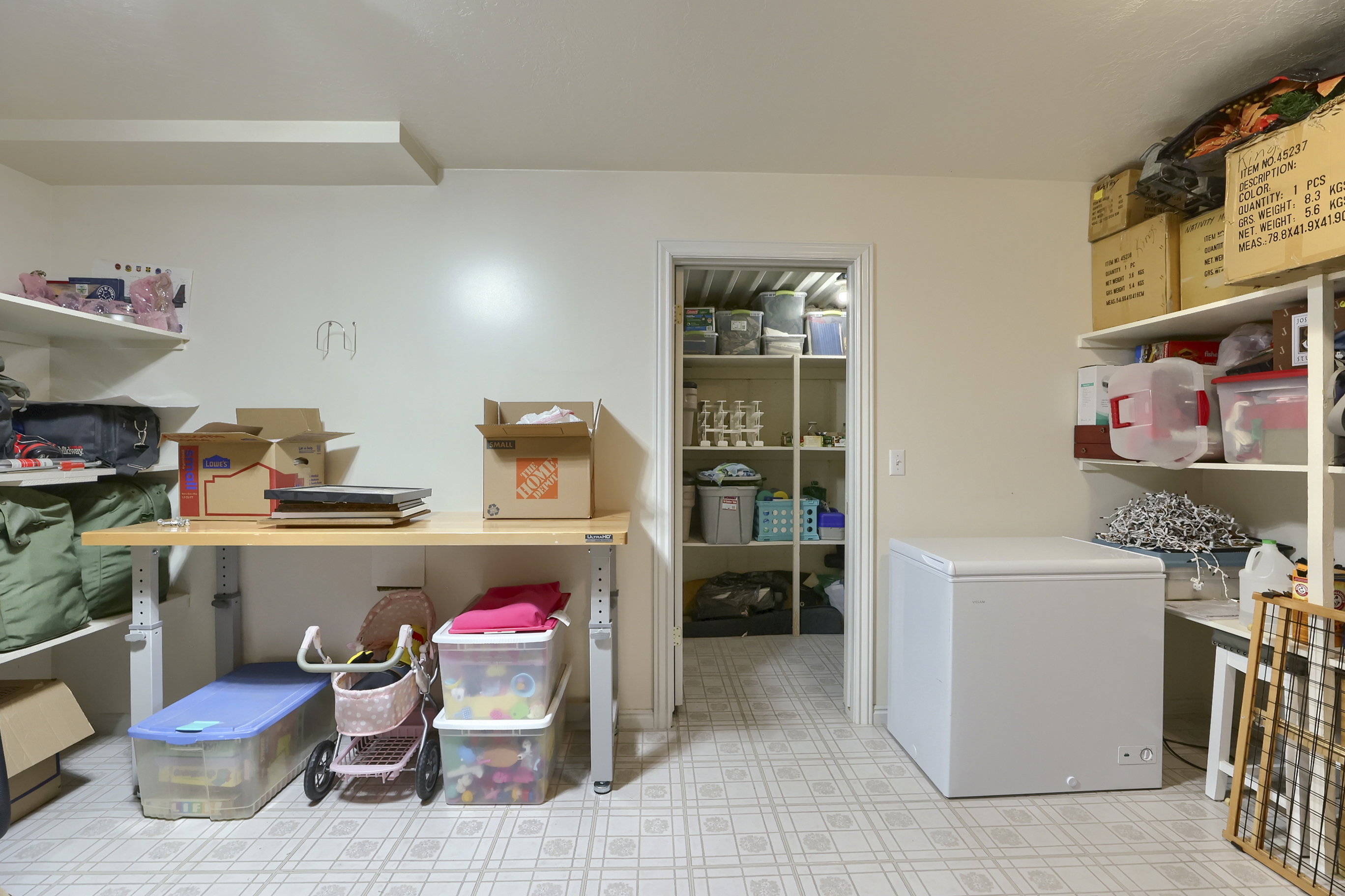 Utility room featuring white walls and patterned flooring