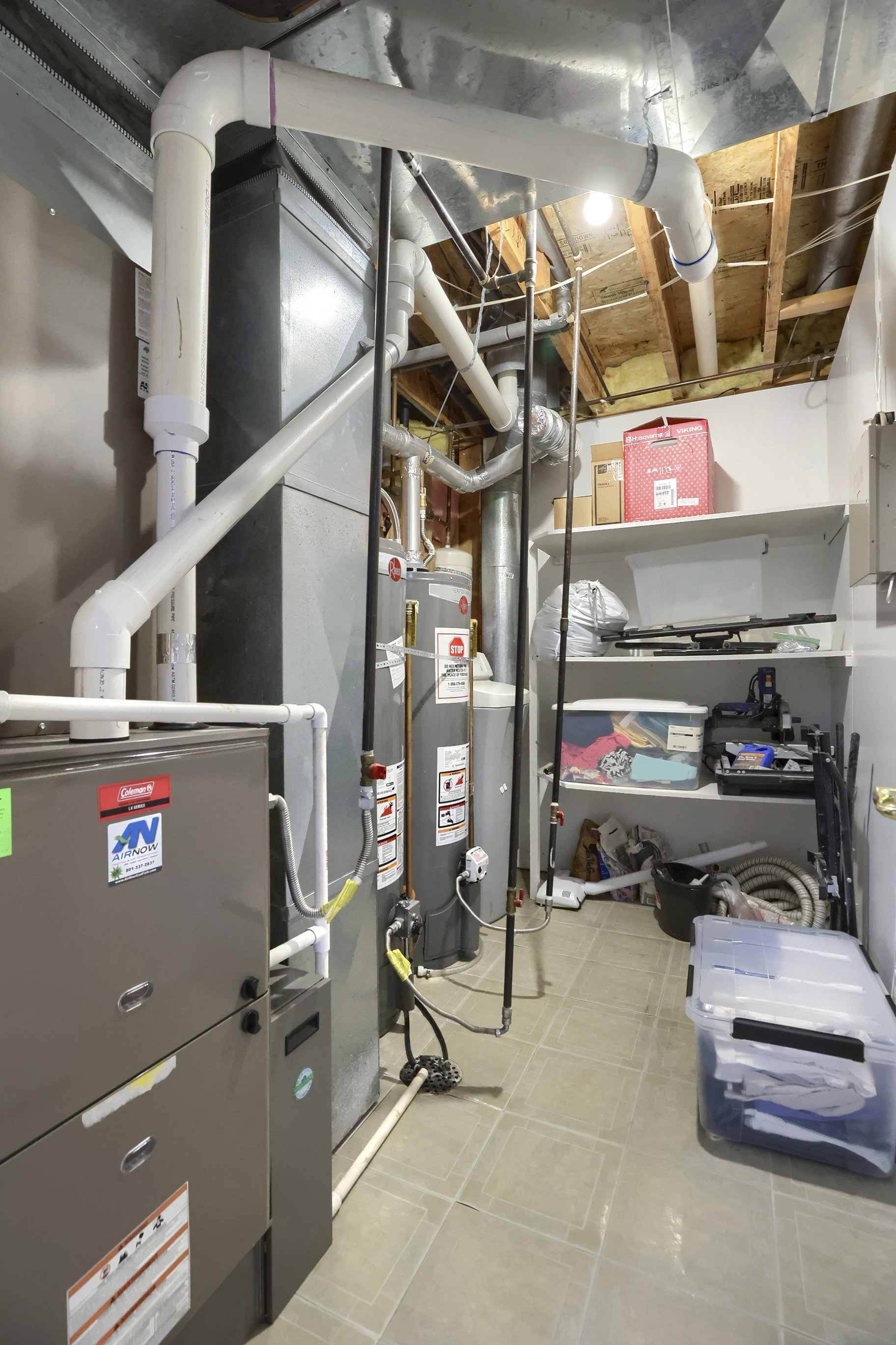 Dedicated utility room featuring mechanical systems, water heater, tile flooring, and integrated shelving