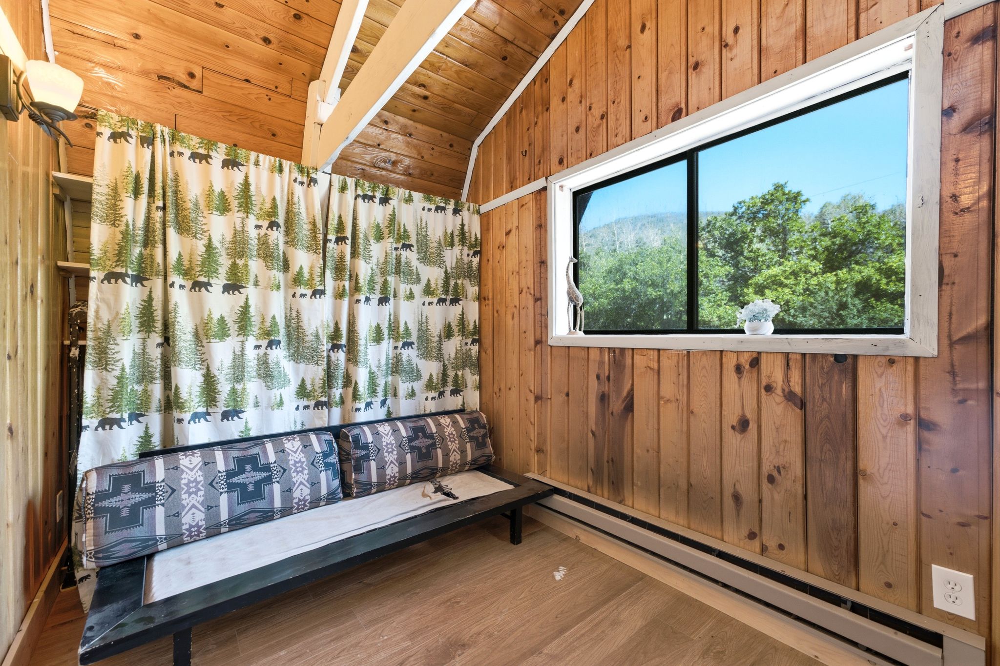 Wood-paneled room with vaulted wood-plank ceiling