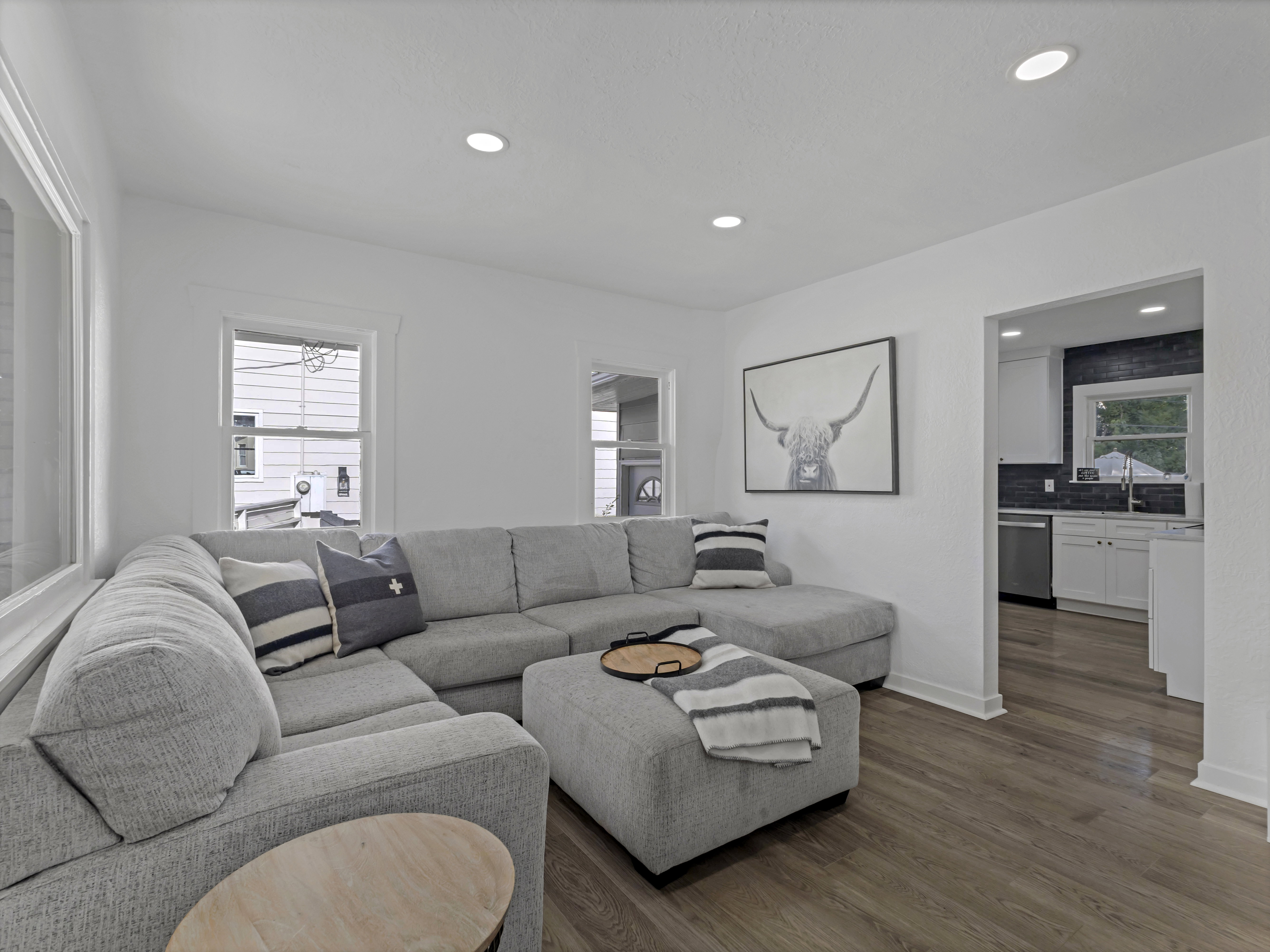 Living area featuring wood-finish flooring, recessed lighting, and white trim