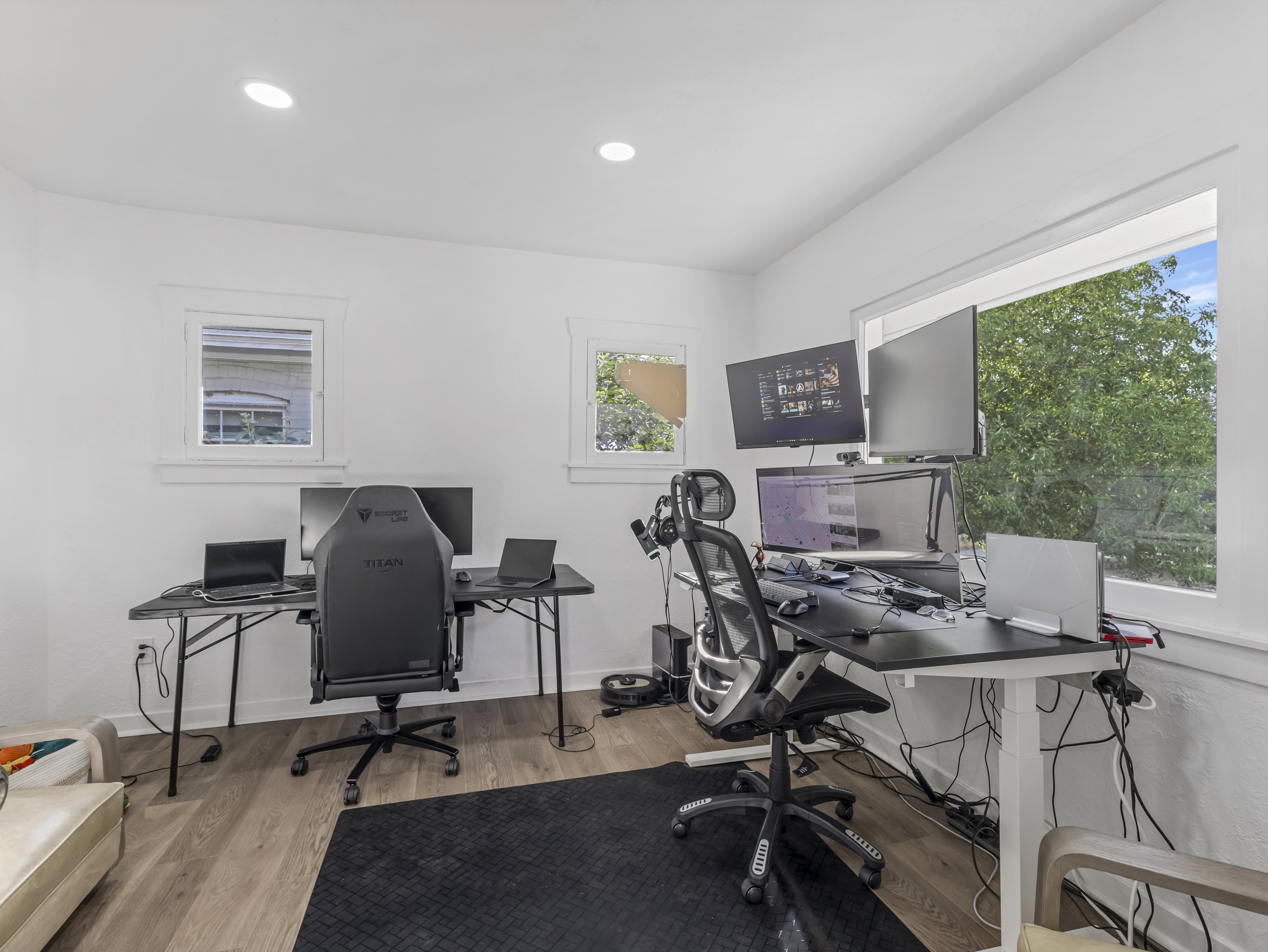 White walls and recessed lighting complement the wood-finish flooring
