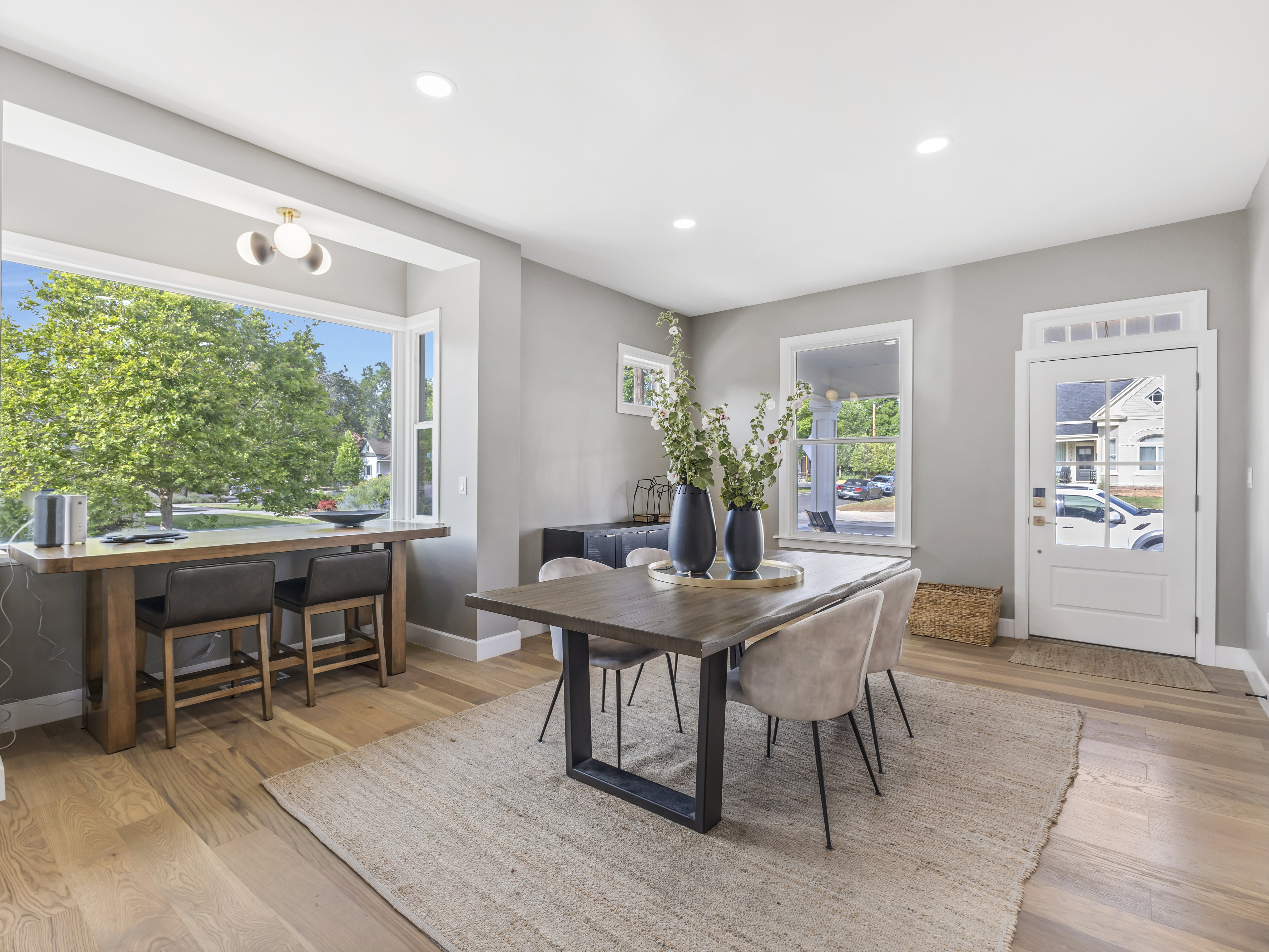 Bright interior featuring a bay window with built-in counter, recessed lighting, and wood-finish flooring