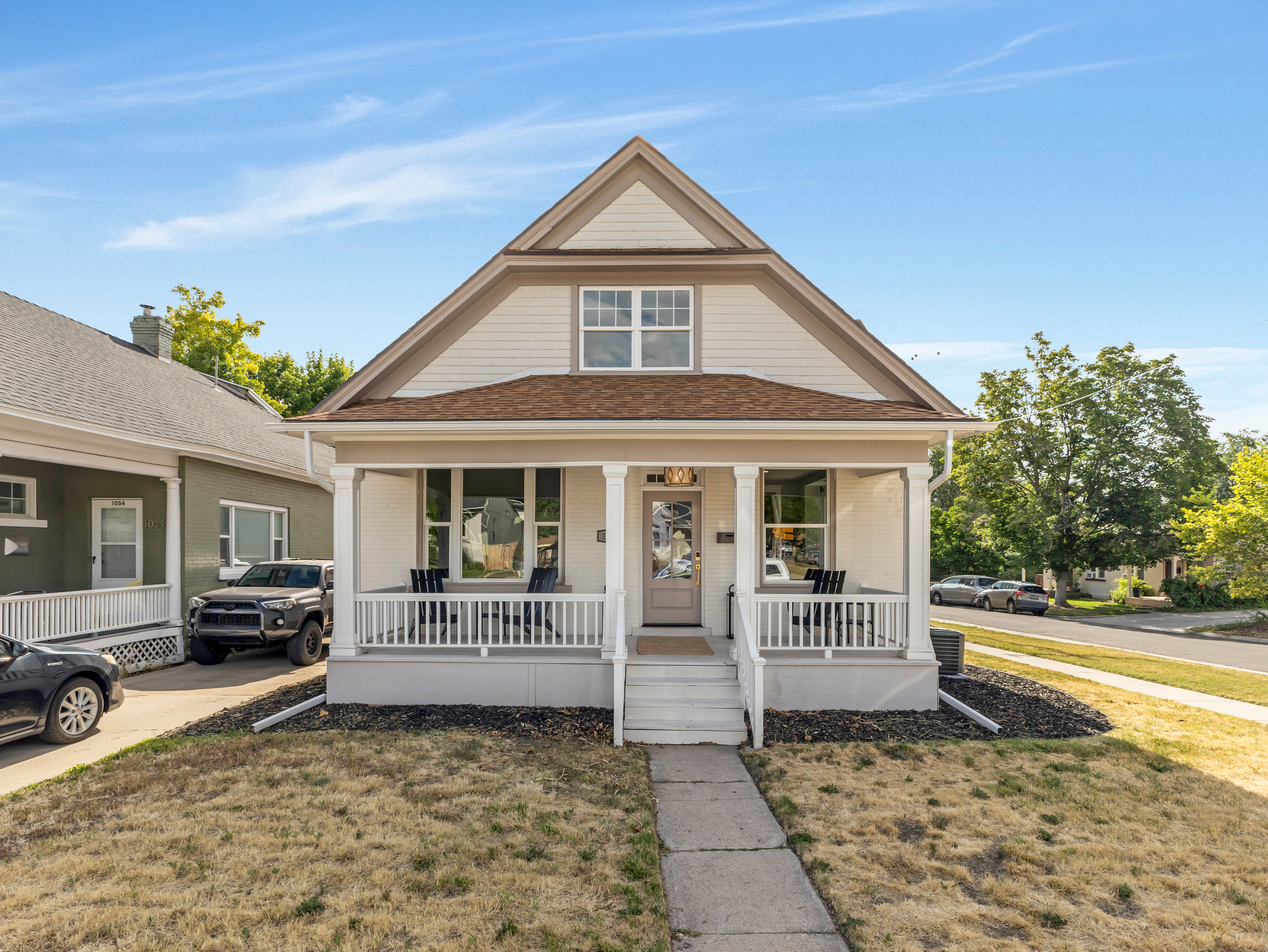 Craftsman-style facade with a covered front porch featuring white railings and columns