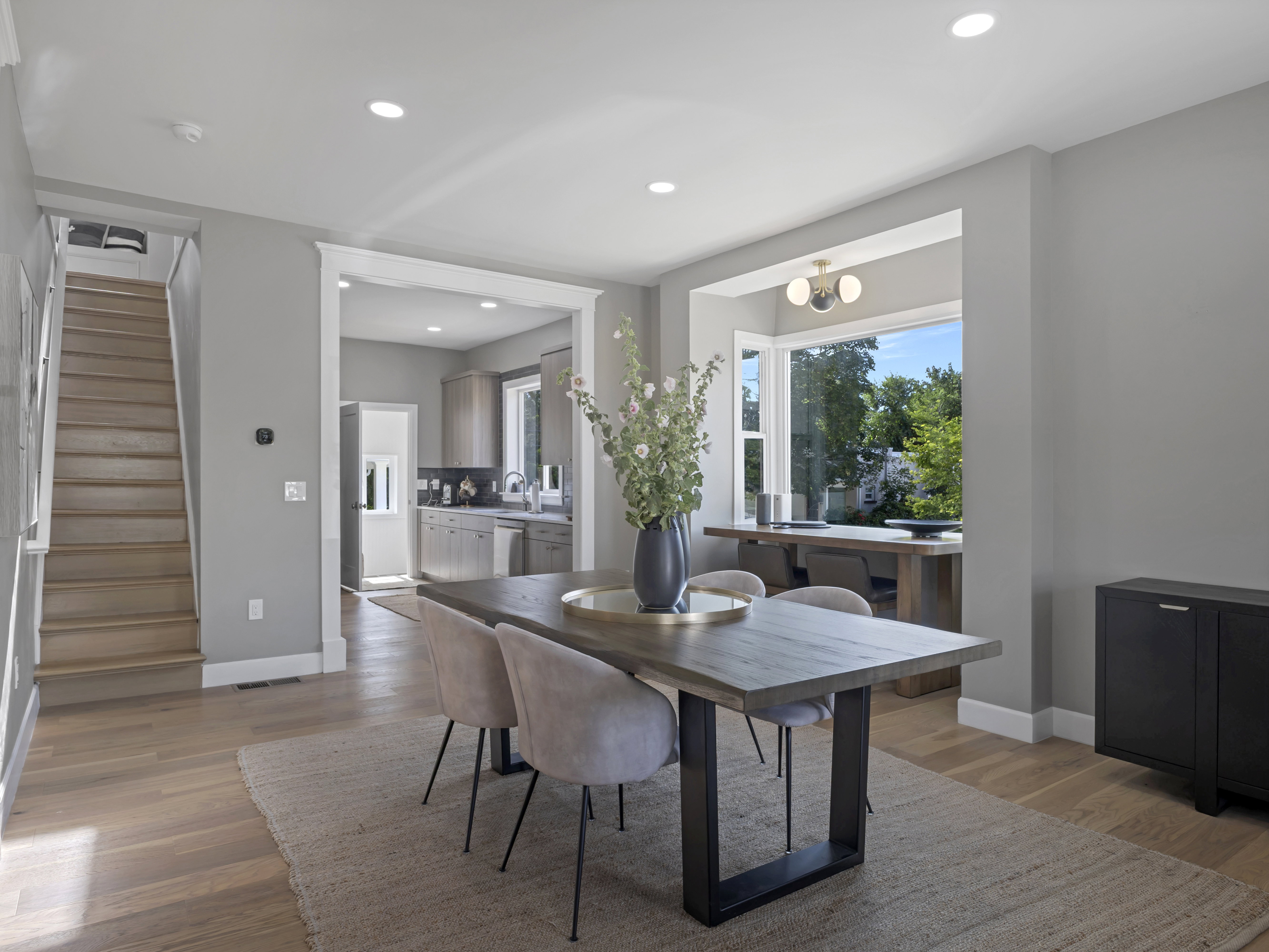Dining area featuring wood-finish flooring, recessed lighting, and a broad window with exterior scenery