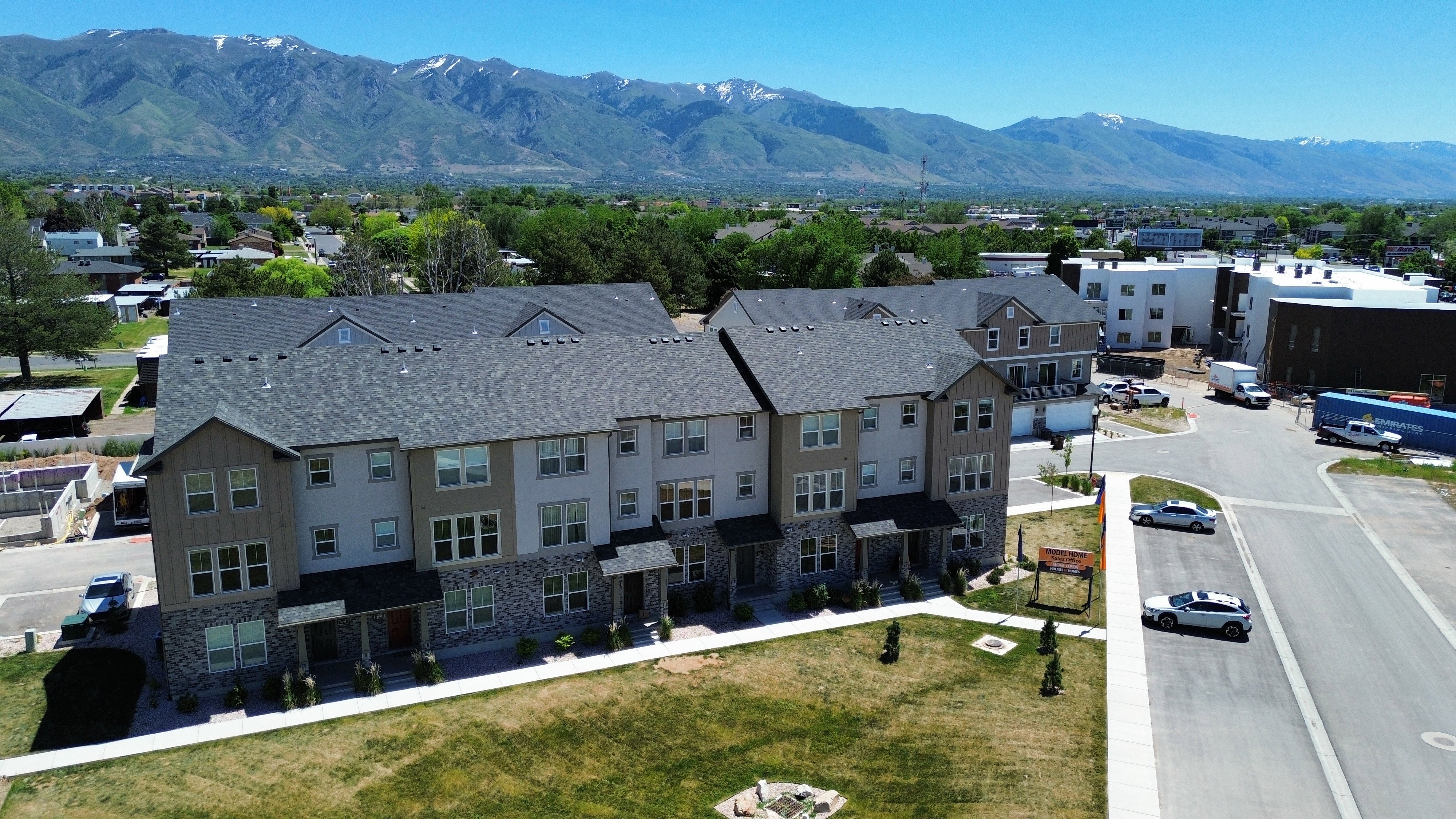 Modern townhome community featuring multi-story residences with stone and siding exteriors