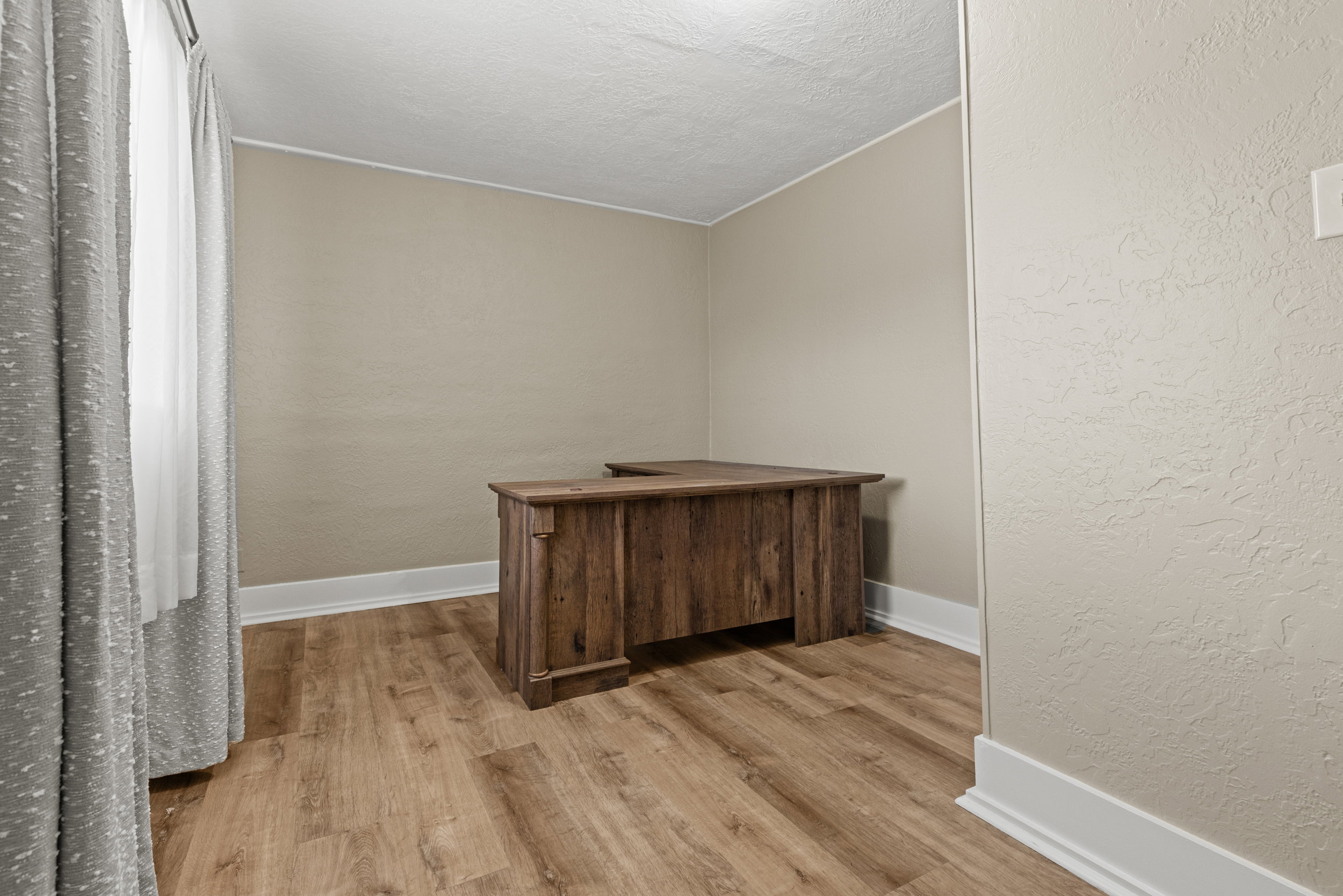 Room featuring wood-finish flooring and neutral wall tones