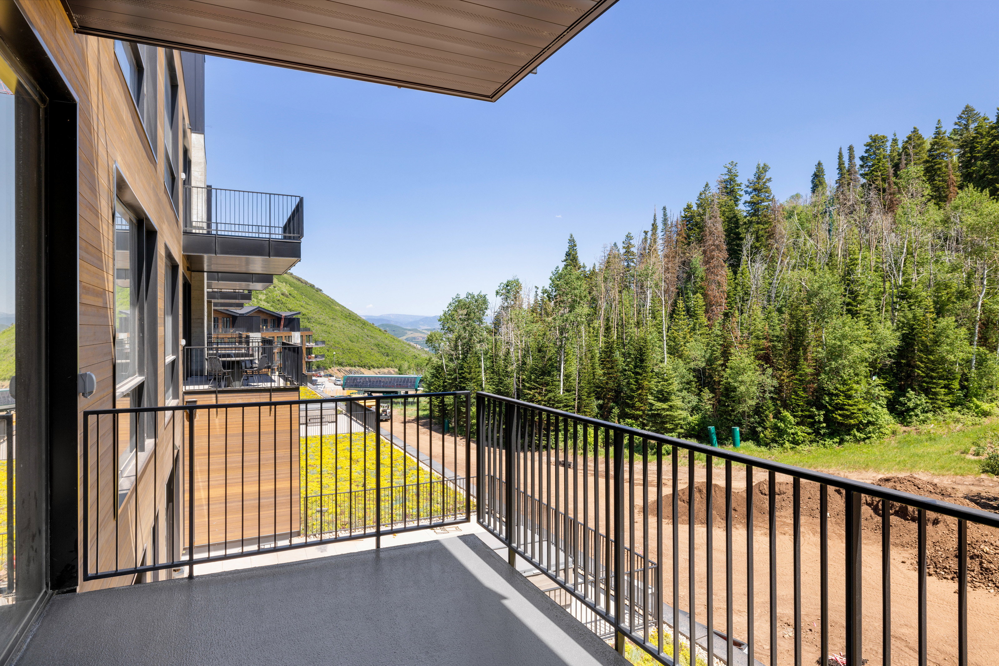 Private outdoor balcony with black metal railing