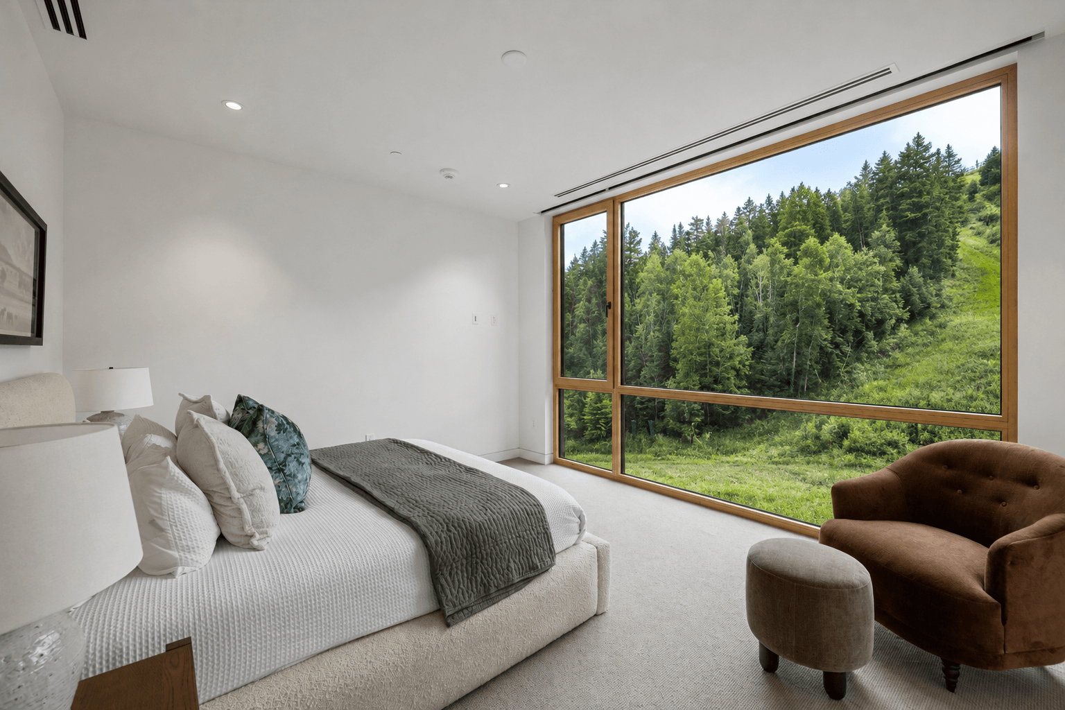 Expansive floor-to-ceiling window system with wood-finish framing