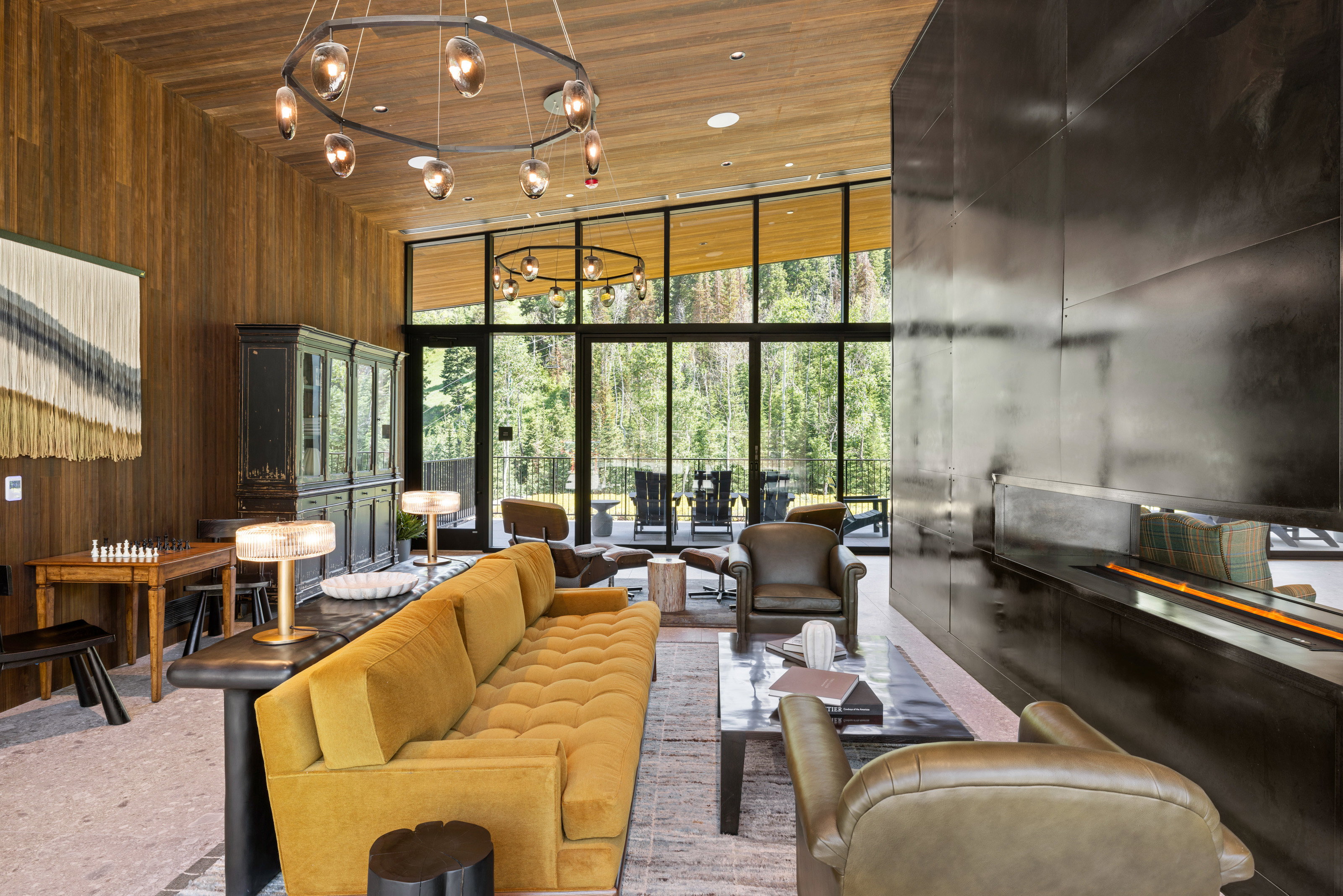 Spacious living area featuring a wood-panel accent wall and a wood-finish ceiling