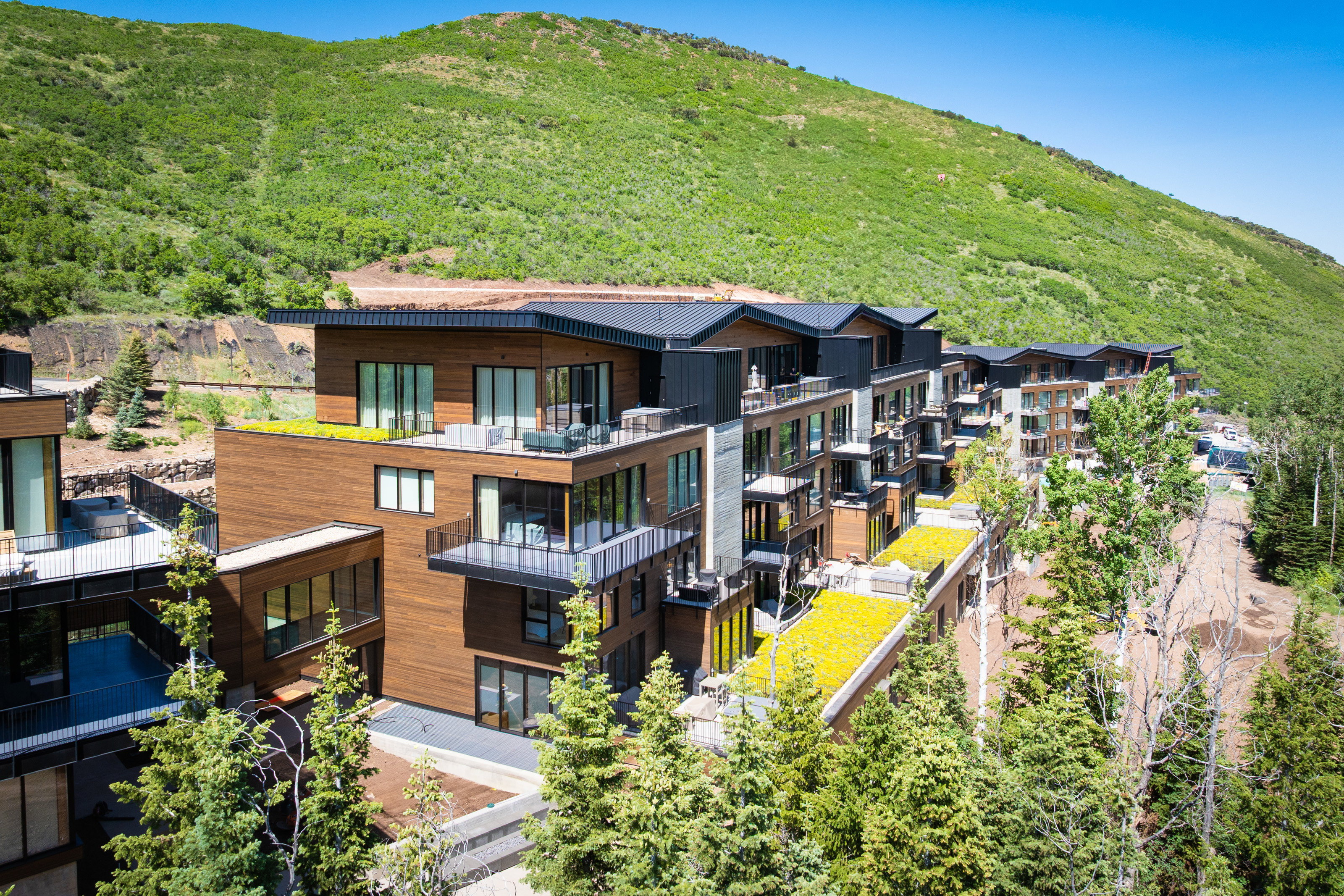Modern multi-story structure featuring extensive wood paneling and black trim