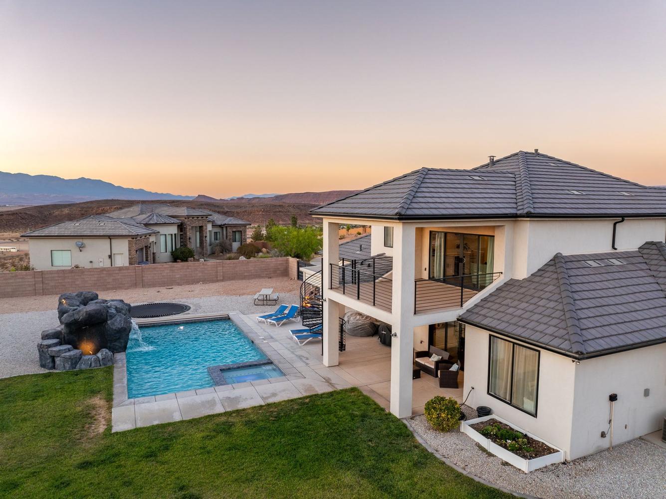 Contemporary stucco exterior with a multi-level tile roof