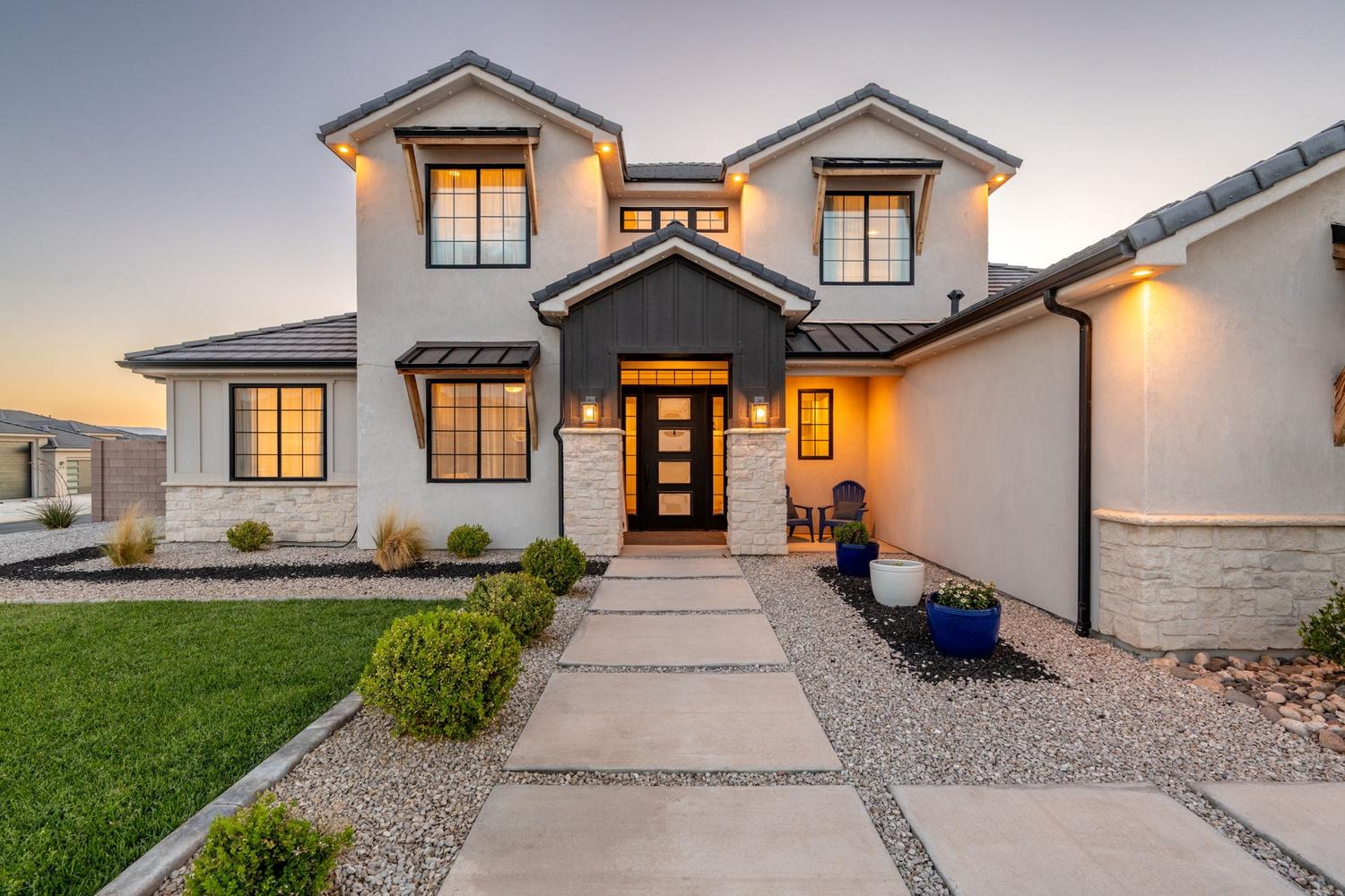 Modern stucco exterior with dark trim accents and stacked stone detailing