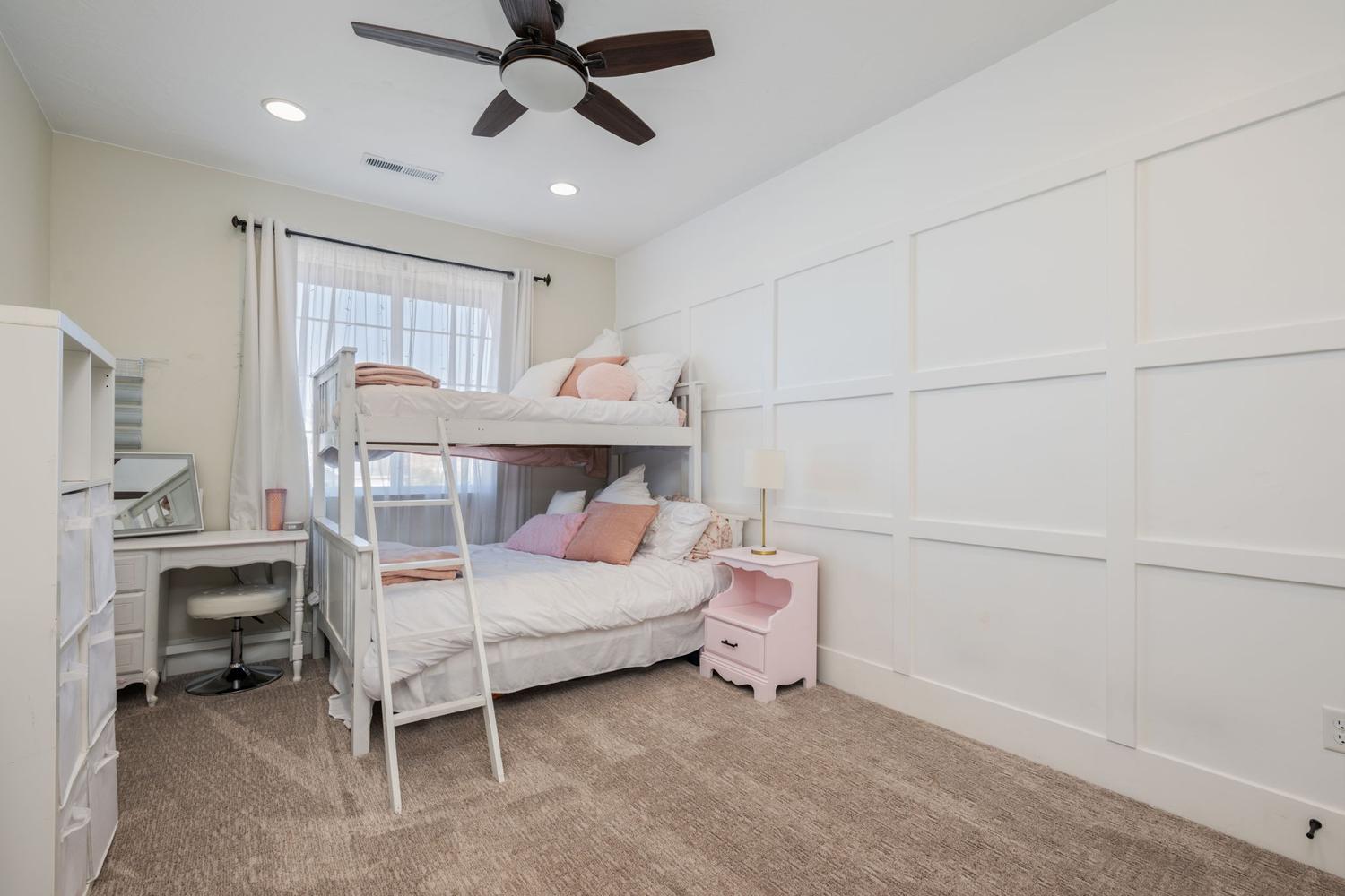 Carpeted interior space featuring a grid accent wall, a window with natural light, recessed lighting, and a ceiling fan
