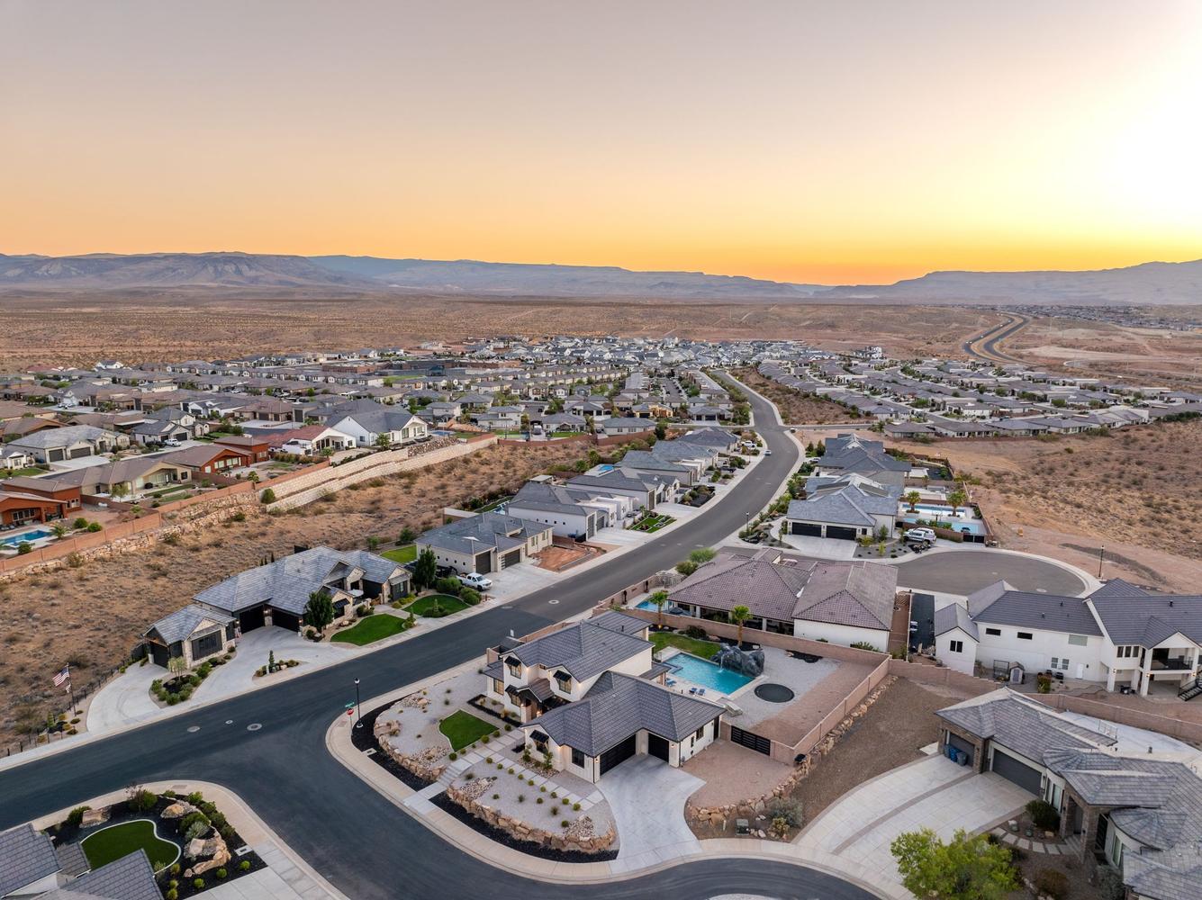 Expansive neighborhood with diverse architectural styles set against a desert landscape