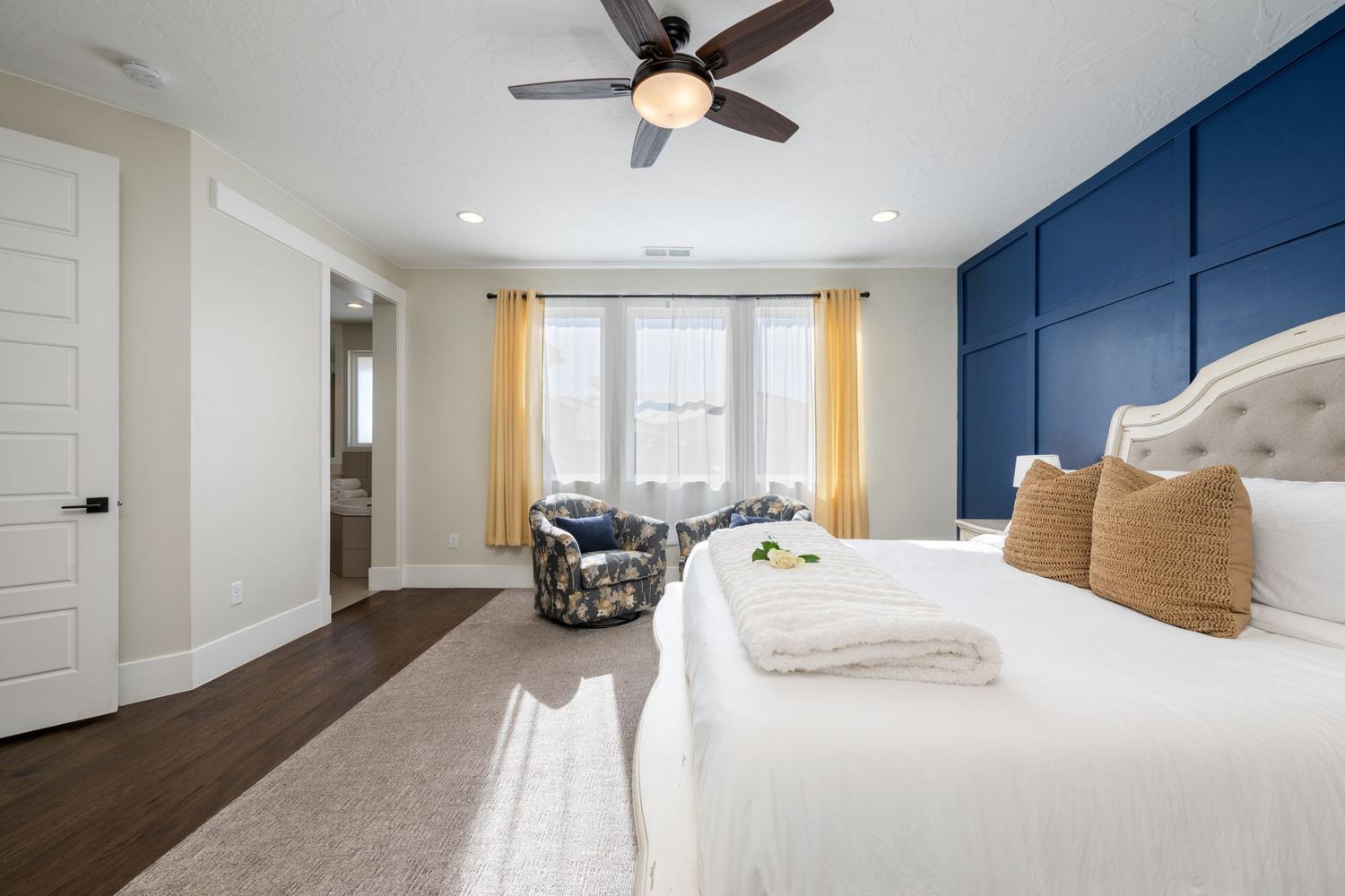 Bedroom featuring a paneled accent wall, a multi-pane window, recessed lighting, and a ceiling fan