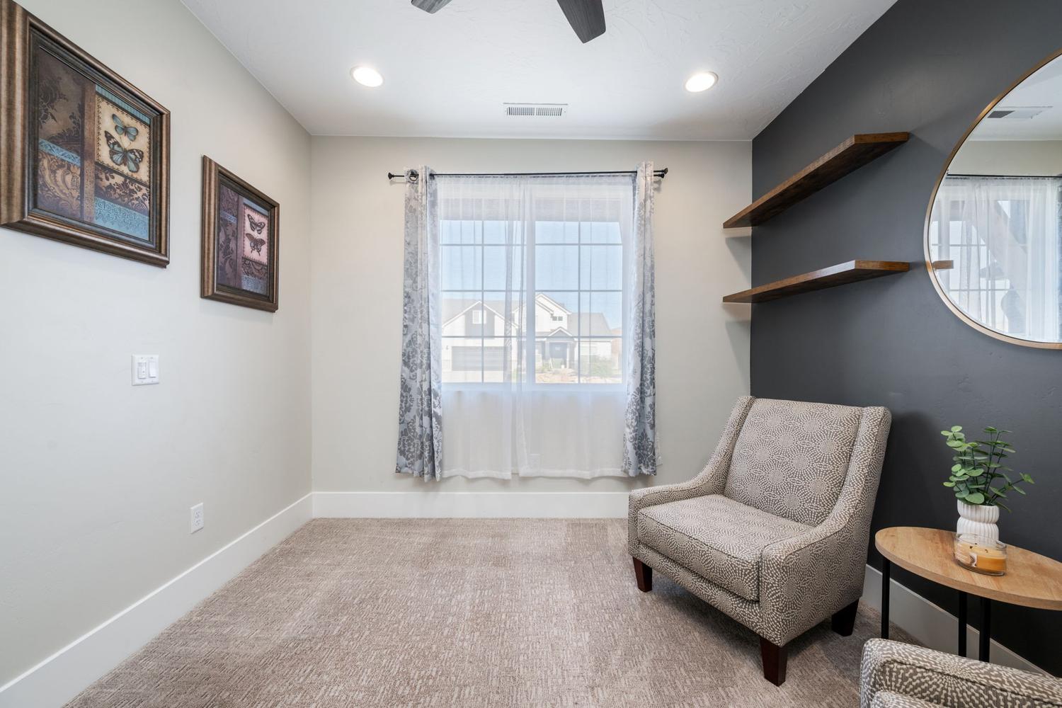 Carpeted room featuring a large window with sheer and patterned curtains, recessed lighting, and a ceiling fan