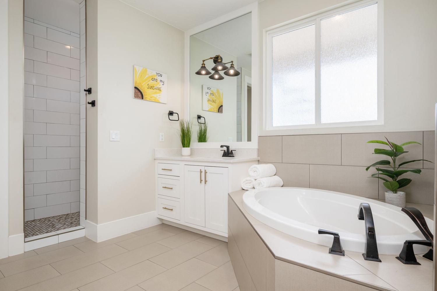Full bathroom featuring a built-in soaking tub with matte black fixtures