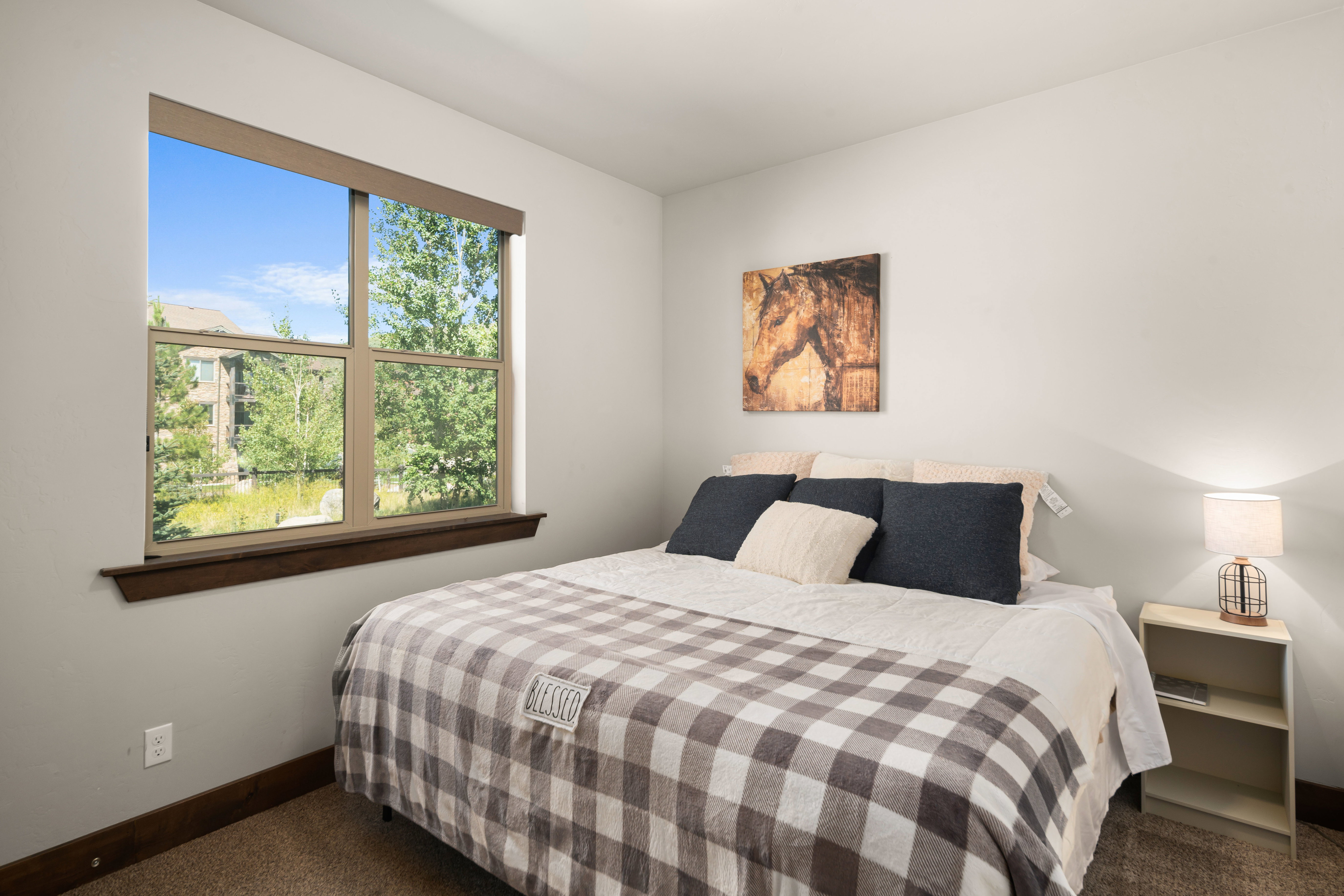 Neutral wall tones with wood-trim window featuring a paneled design