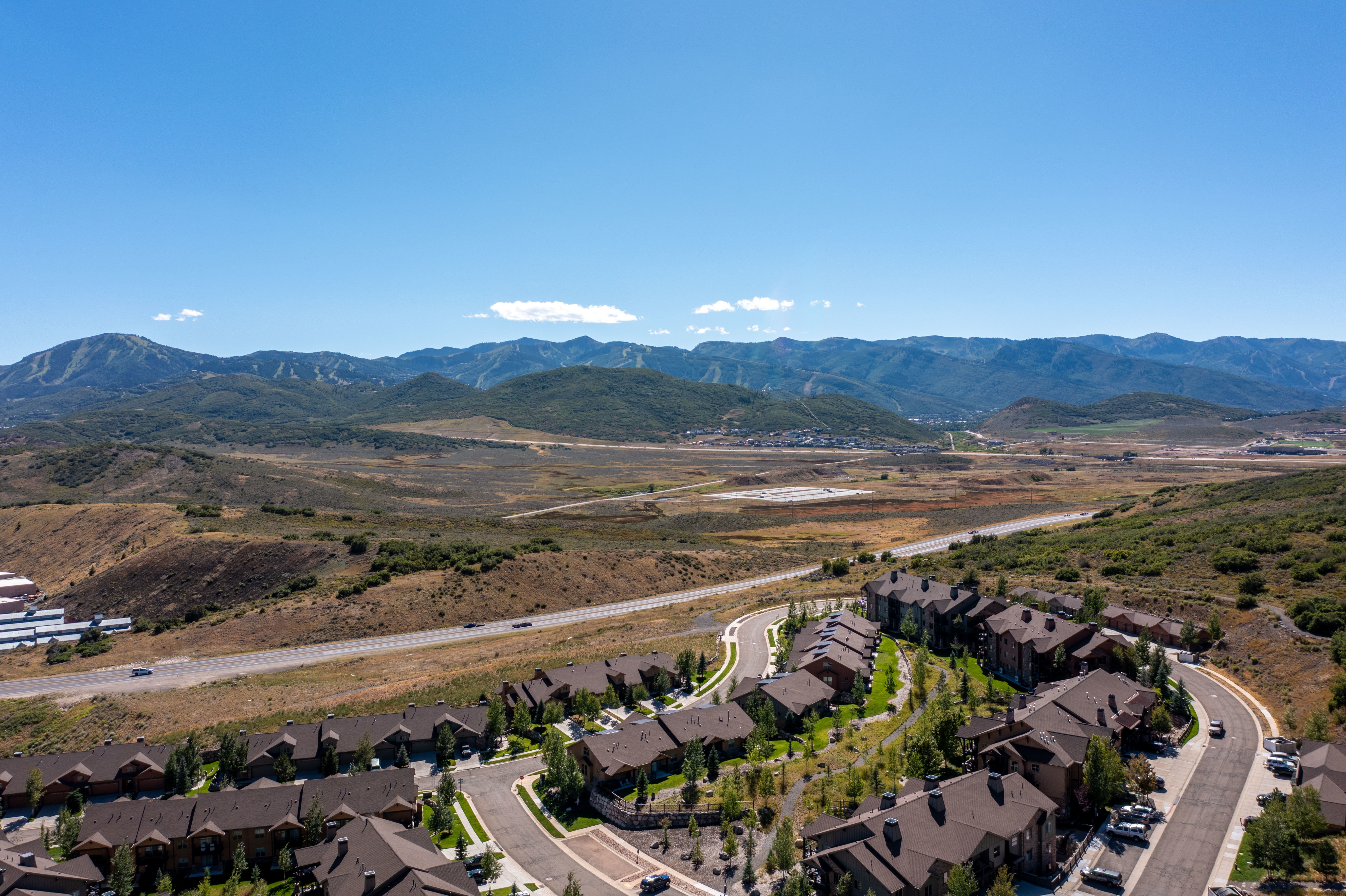 Community development featuring multi-story residences with dark roofs and light-colored siding