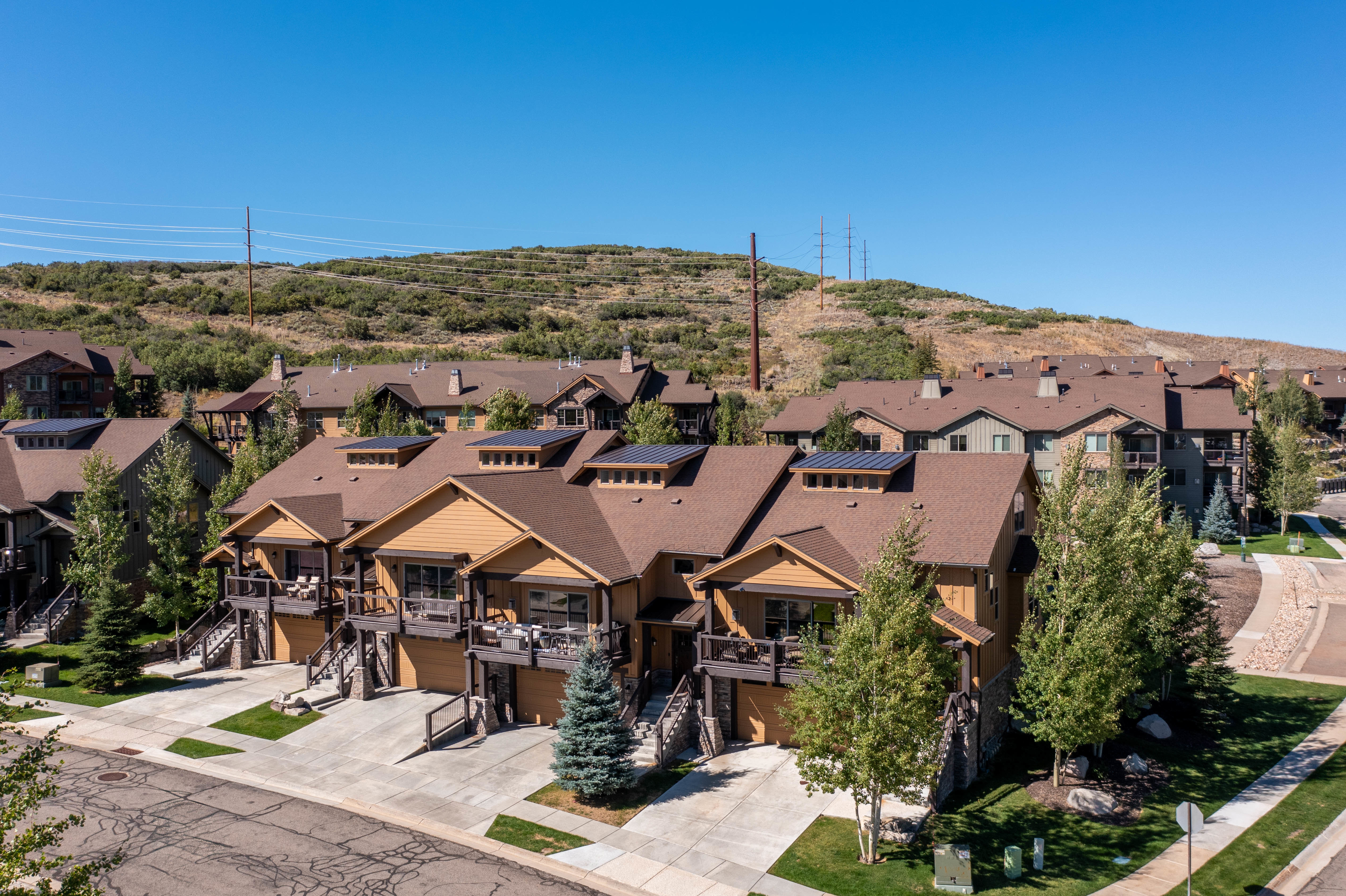Modern townhome-style residences featuring multi-level construction, private balconies, and individual garages