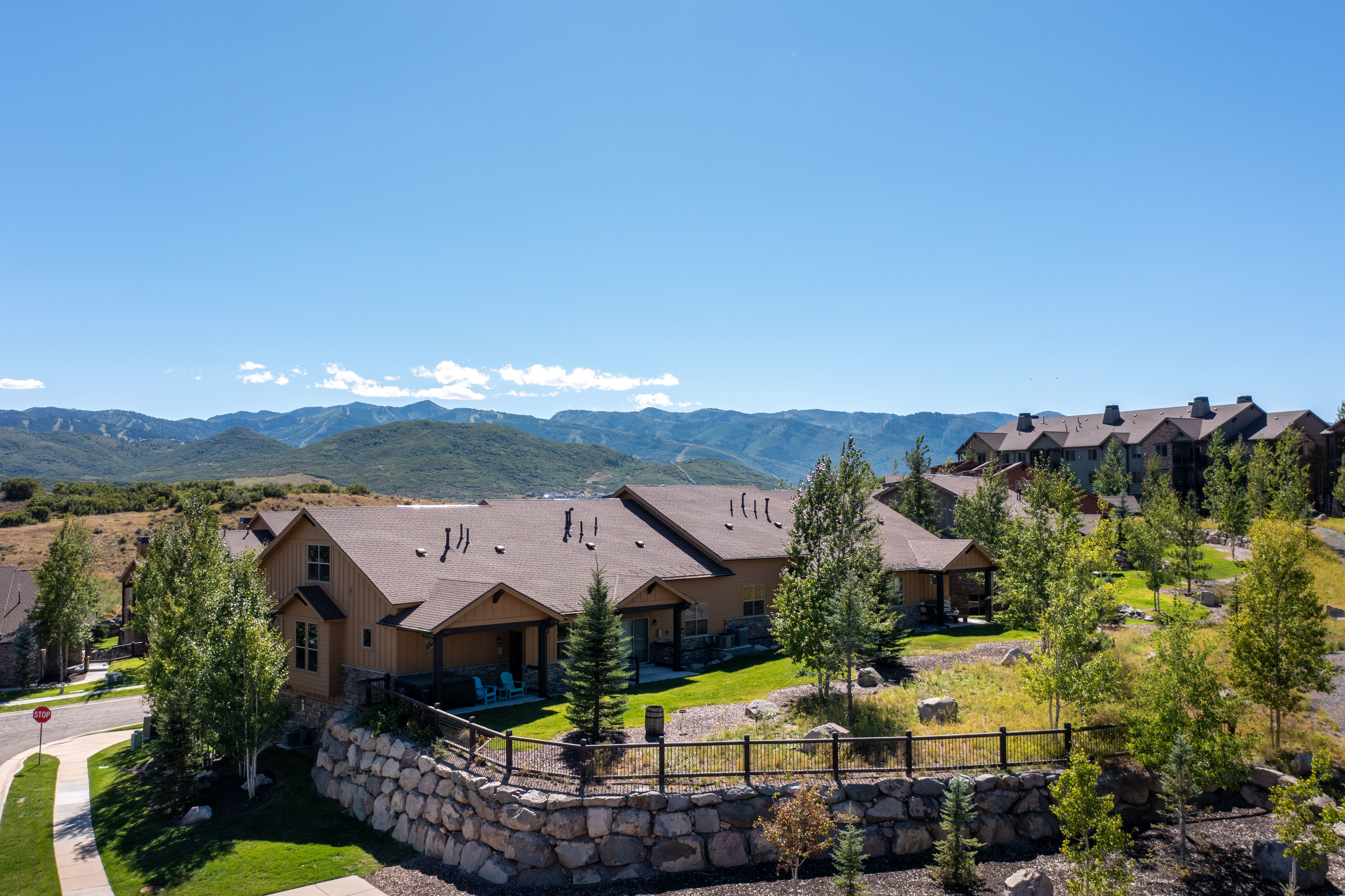 Mountain-style architectural design with a natural wood siding and stone facade