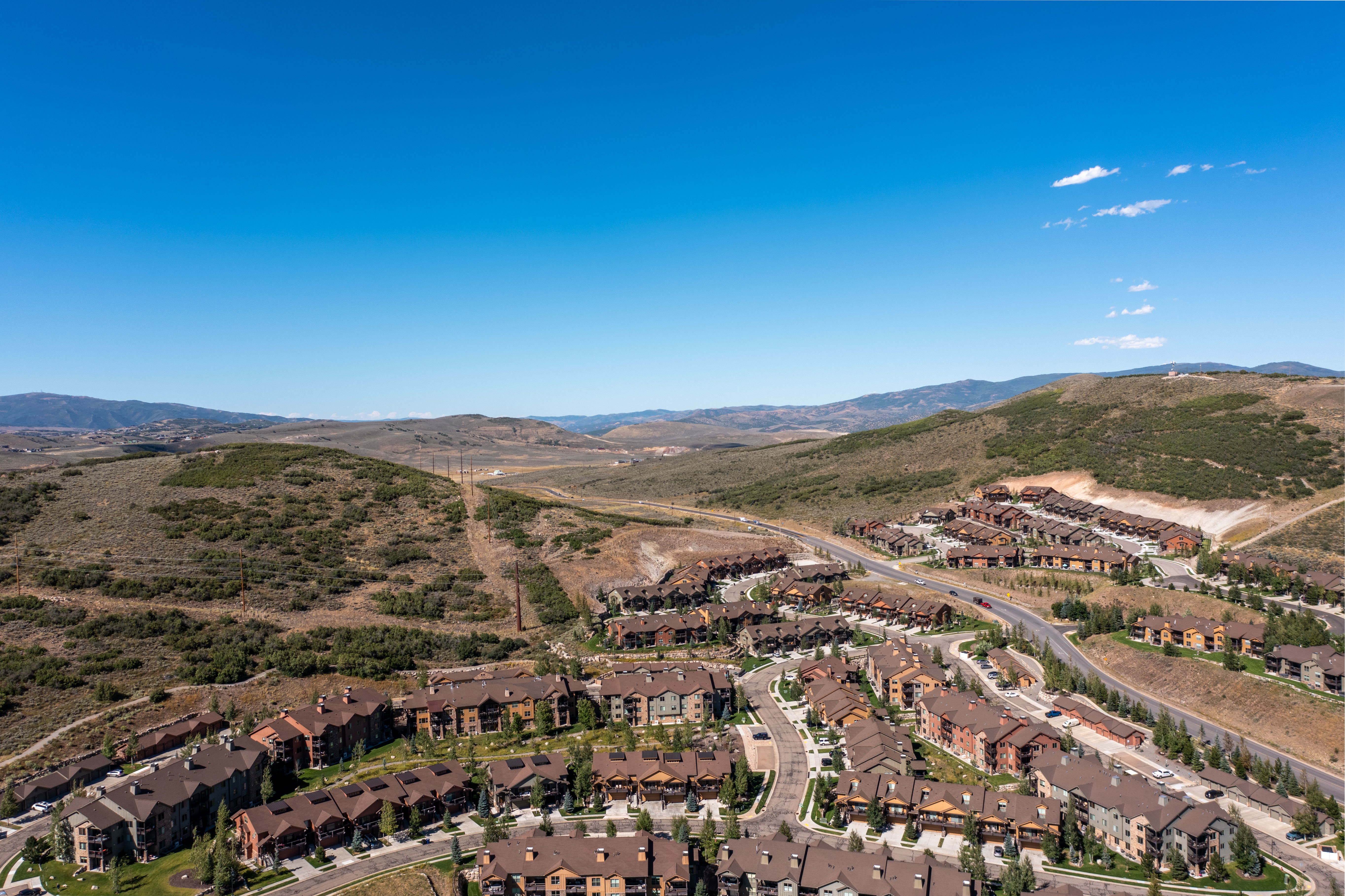 Aerial perspective showcasing a residential development nestled within a mountainous landscape