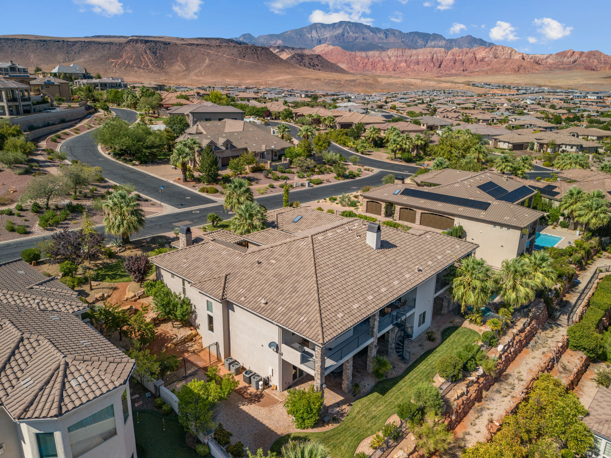 Expansive property featuring a multi-level design, a large tiled roof, and a spiral staircase