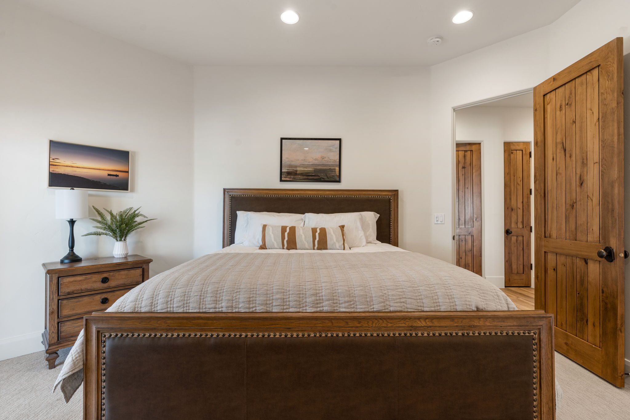 Carpeted bedroom featuring white walls and recessed lighting