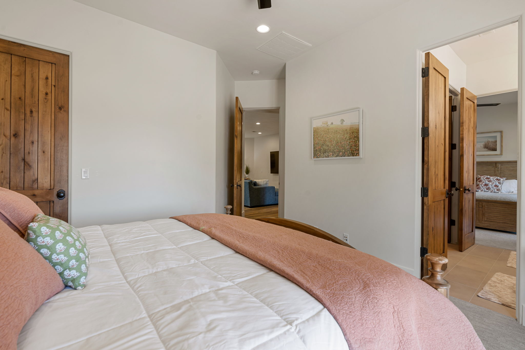 Interior room featuring light-toned walls, wood-finish interior doors, and a ceiling-mounted light fixture