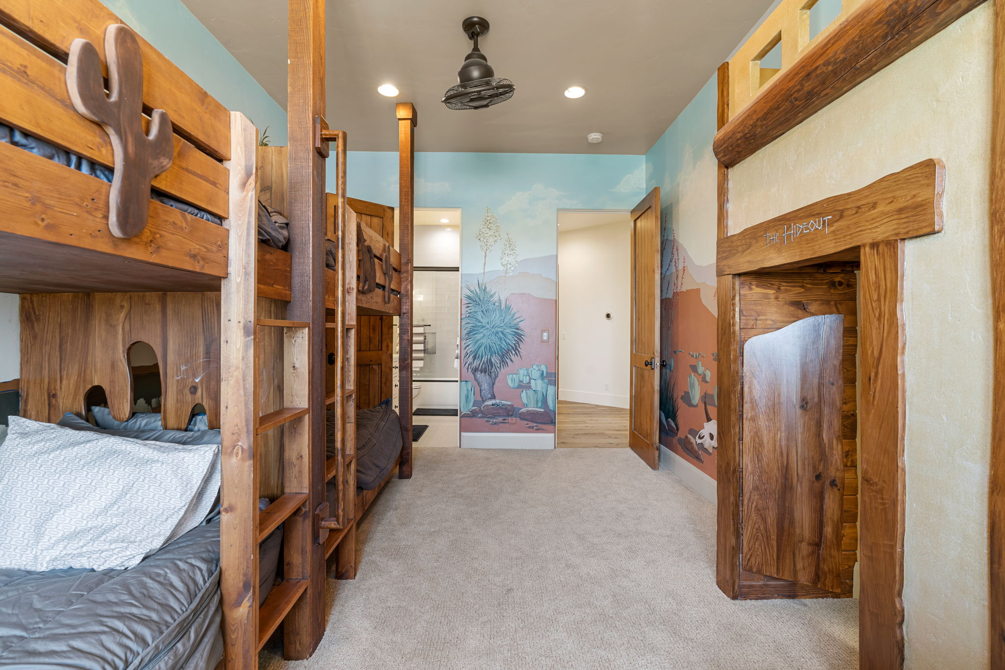 Custom-built bunk beds with integrated ladders and carved wood accents
