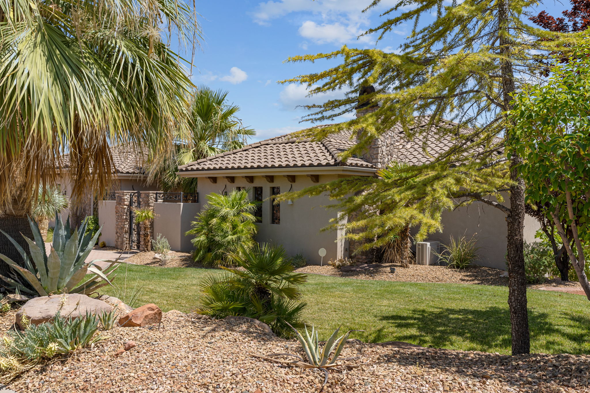 Exterior with a tiled roof, stucco finish, and multiple windows