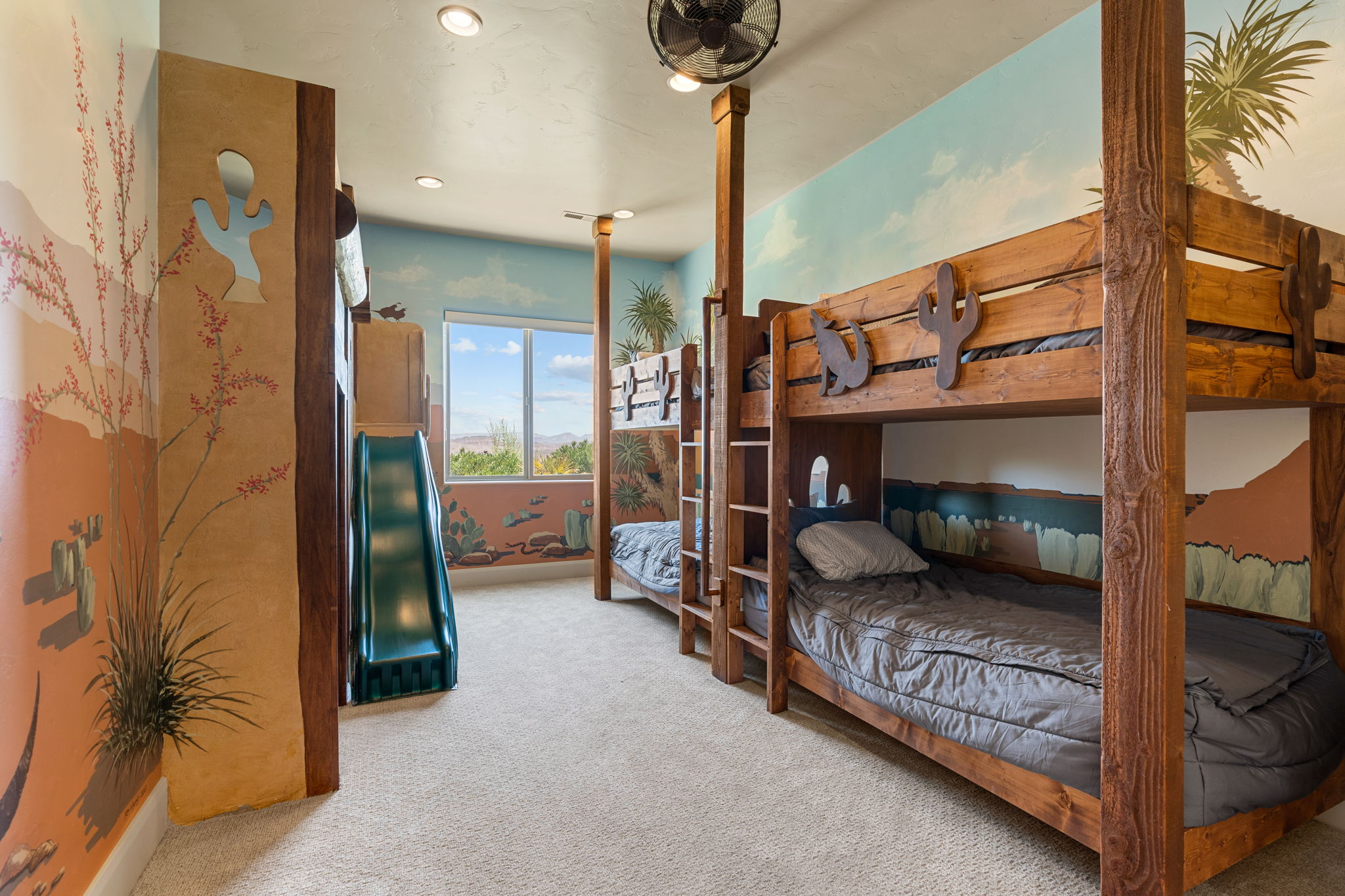 Room featuring built-in bunk beds with ladder access, a permanent slide structure, and recessed ceiling lighting