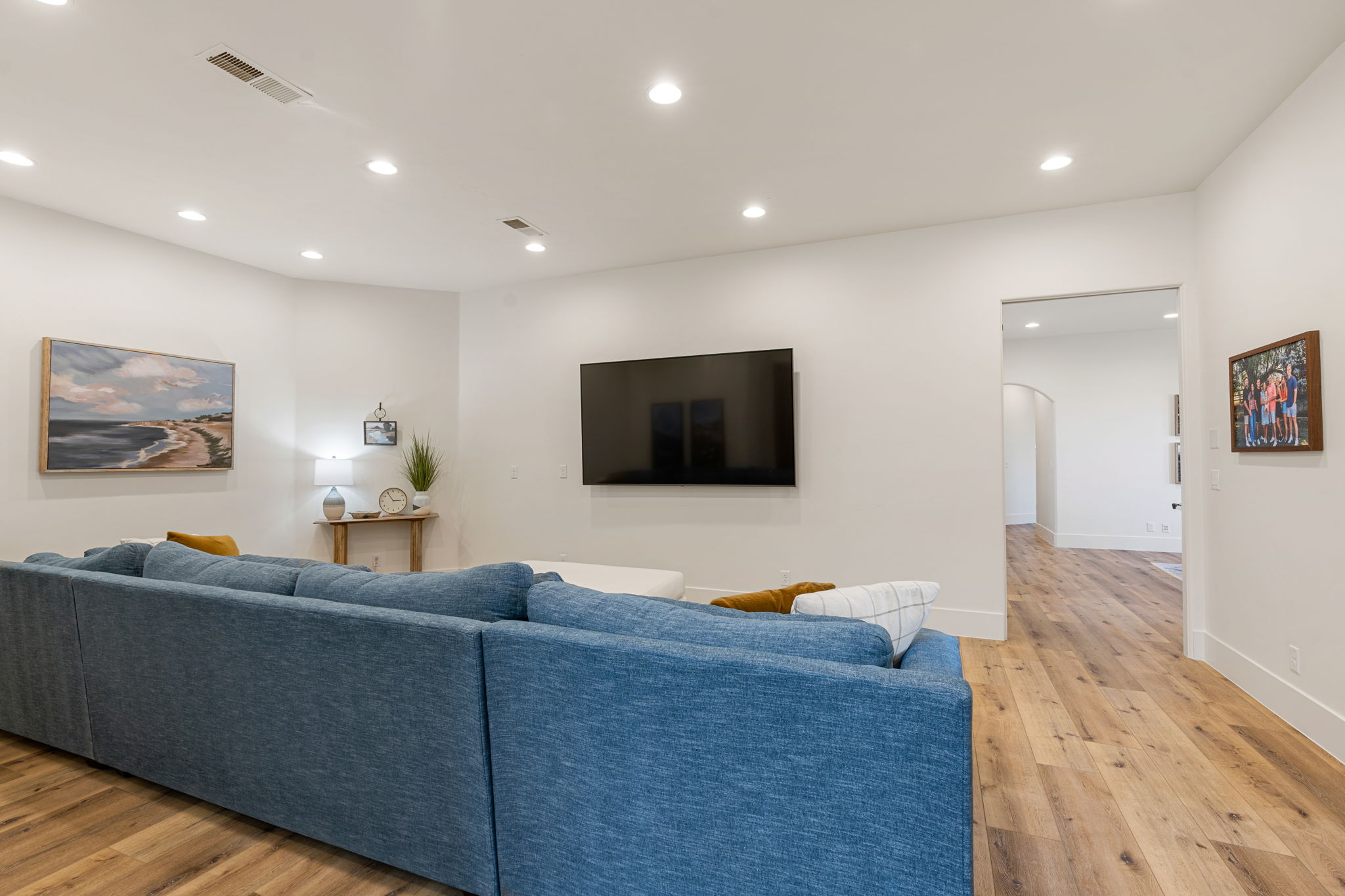 Spacious interior with neutral walls, recessed lighting, and wood-finish flooring