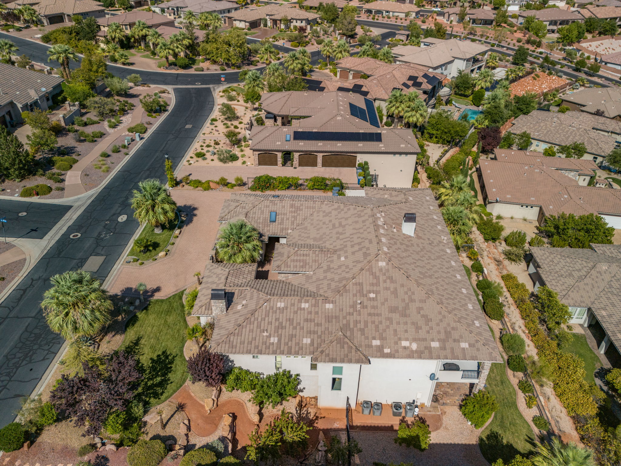 Expansive property featuring a multi-level architectural design, a tiled roofing system, and desert-adapted landscaping