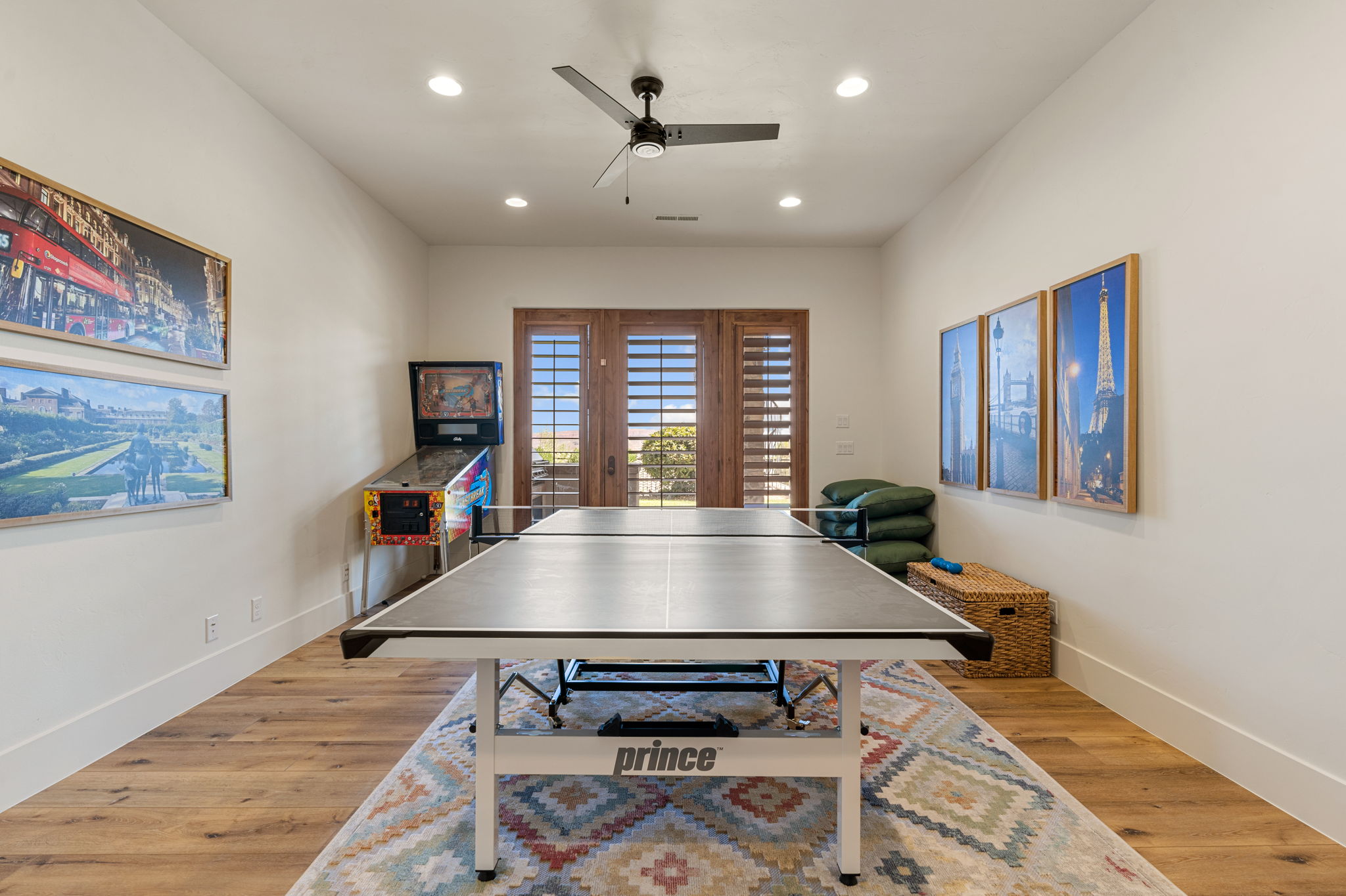Spacious room featuring wood-finish flooring, recessed lighting, and a ceiling fan
