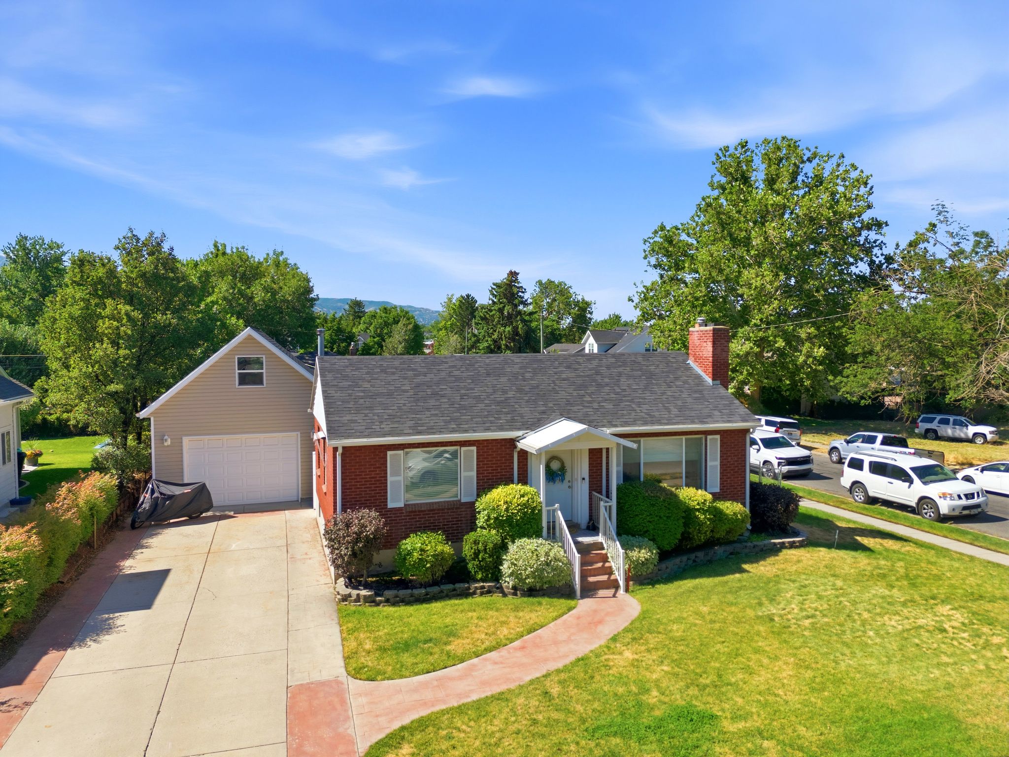 Brick exterior featuring a gabled roof and white trim