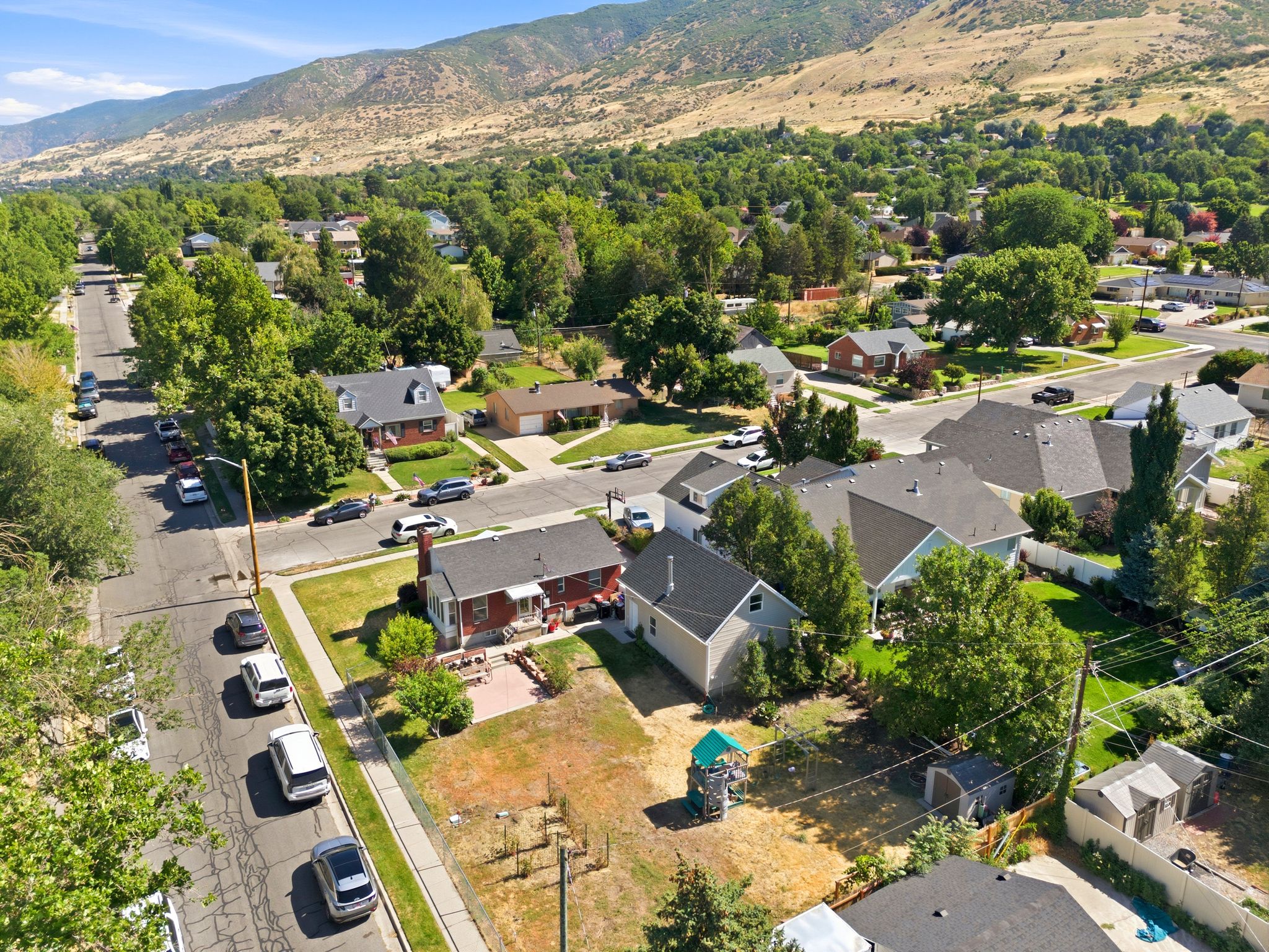 Residential neighborhood featuring mature trees and mountain topography